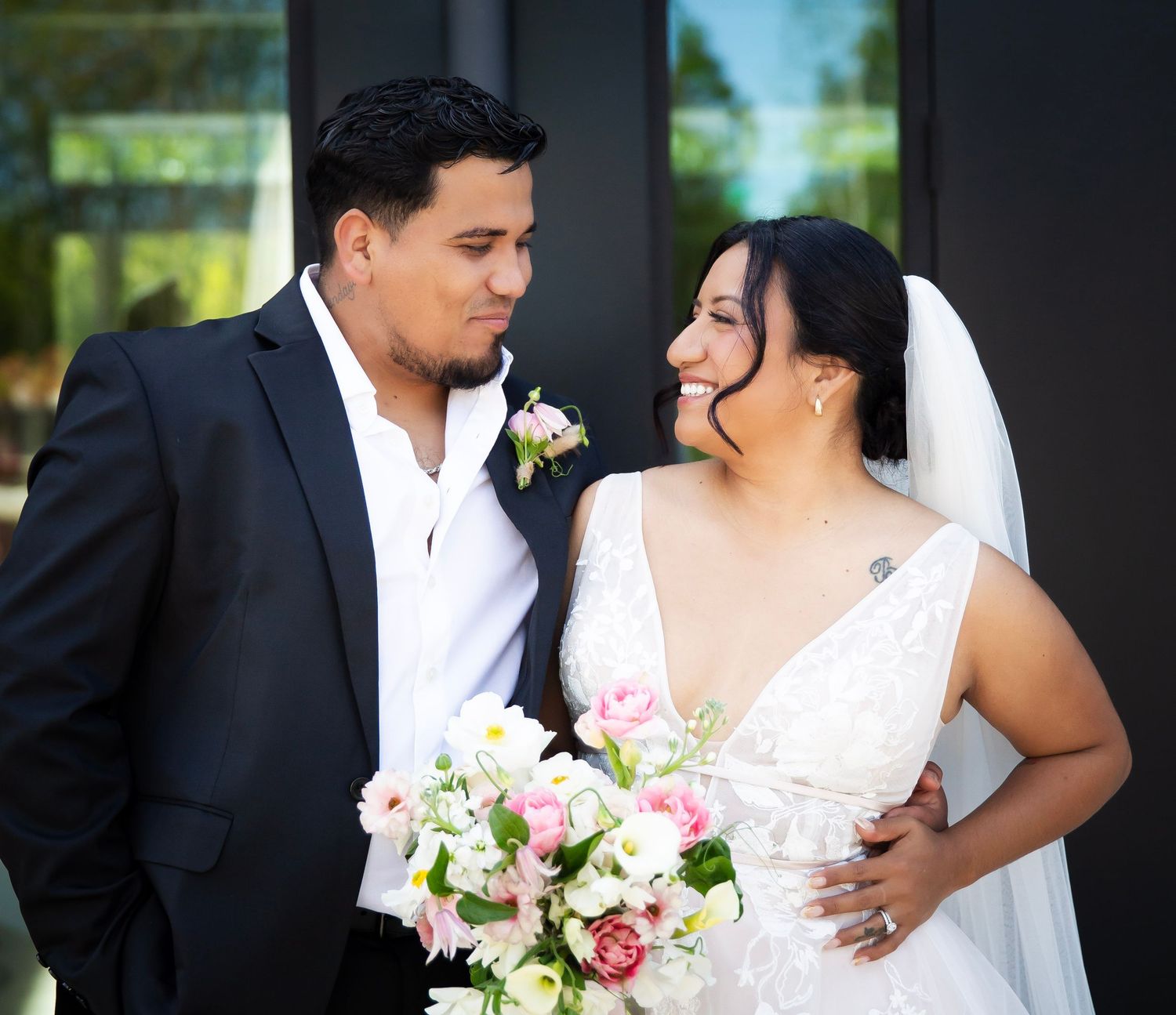 Bride and groom looking happily into one another's eyes