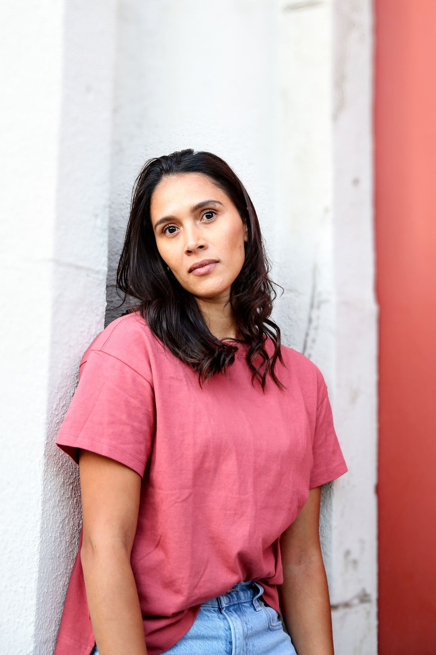 Female model leaning against a wall