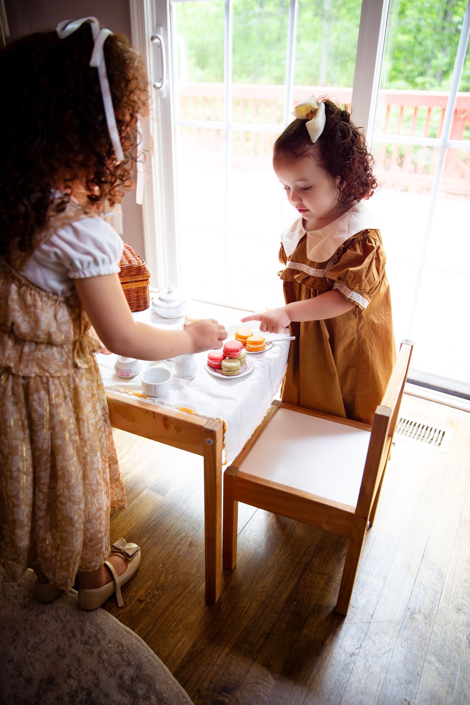 Little sisters with play tea set