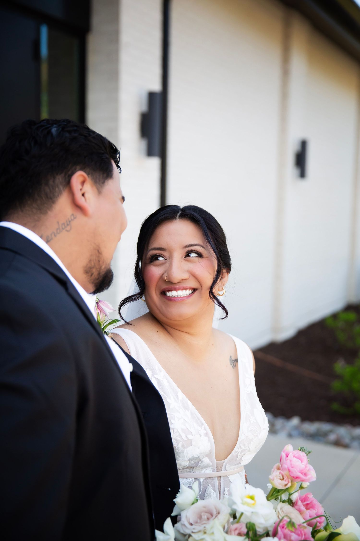 Bride looking happily into groom's eyes