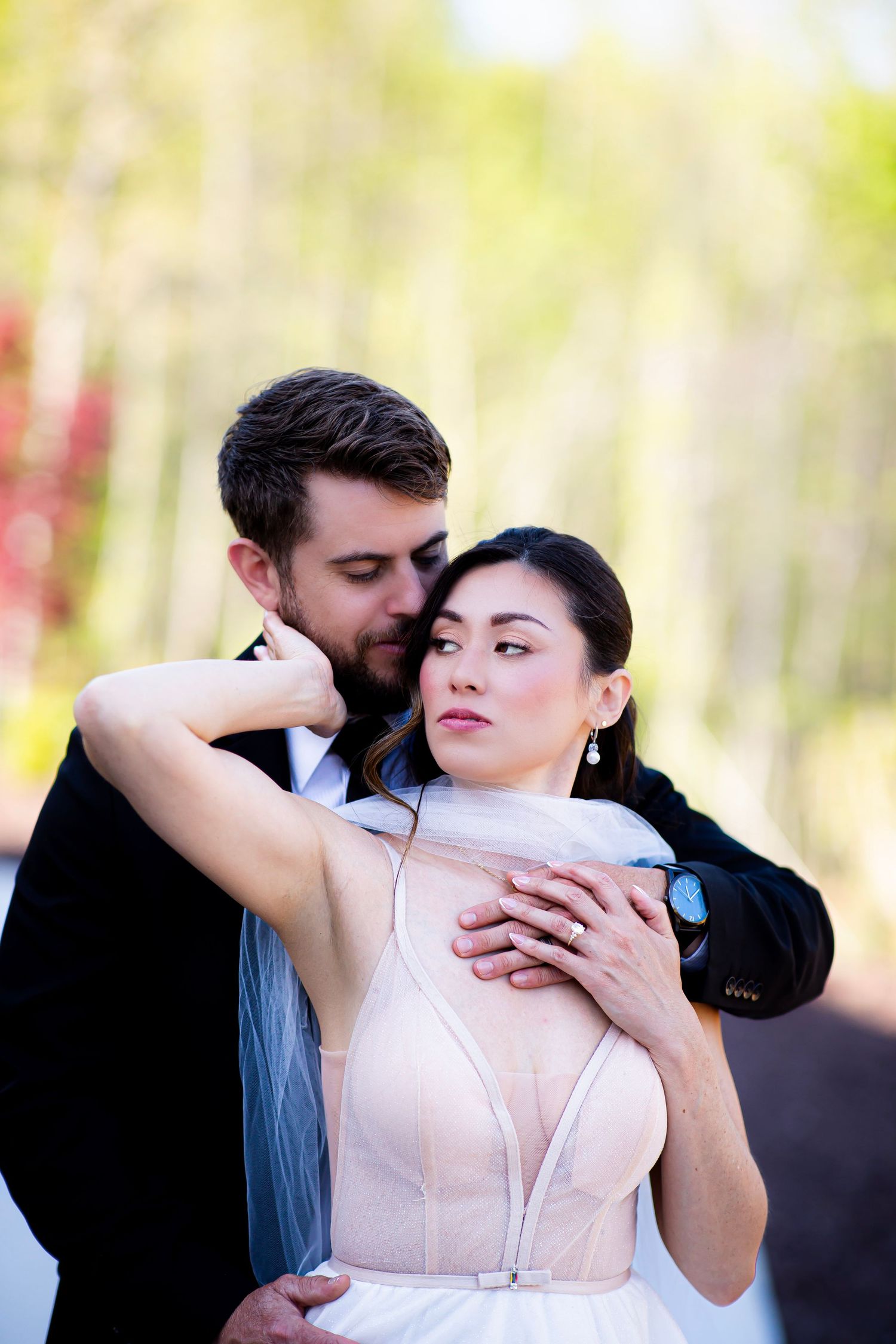 Bride and groom in affectionate hold.