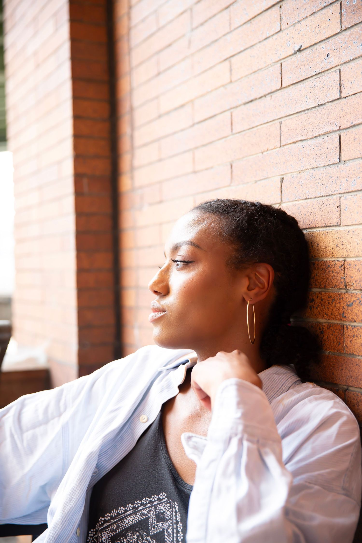 Female model sitting with chin on hand
