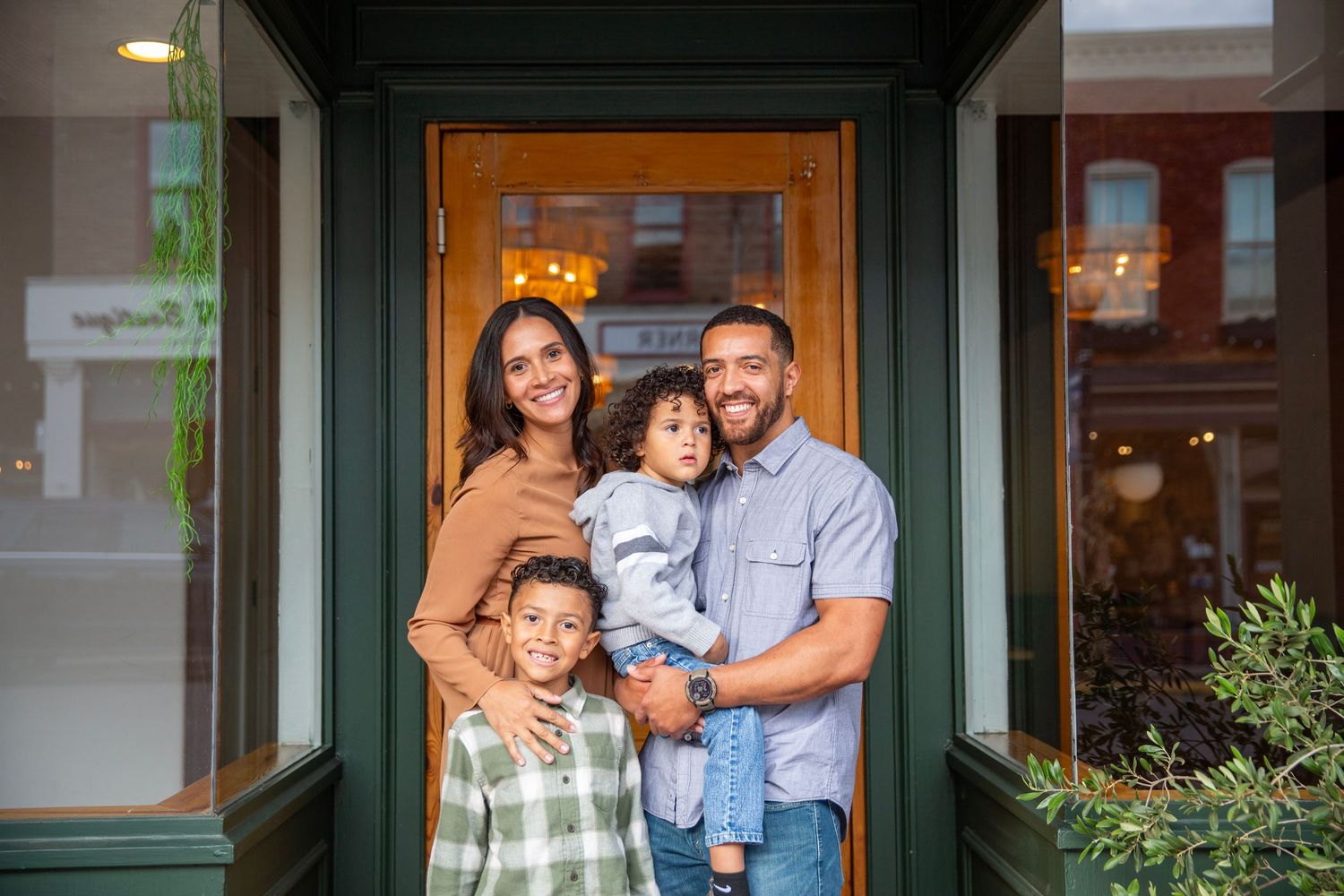 Family of four in a smiling pose