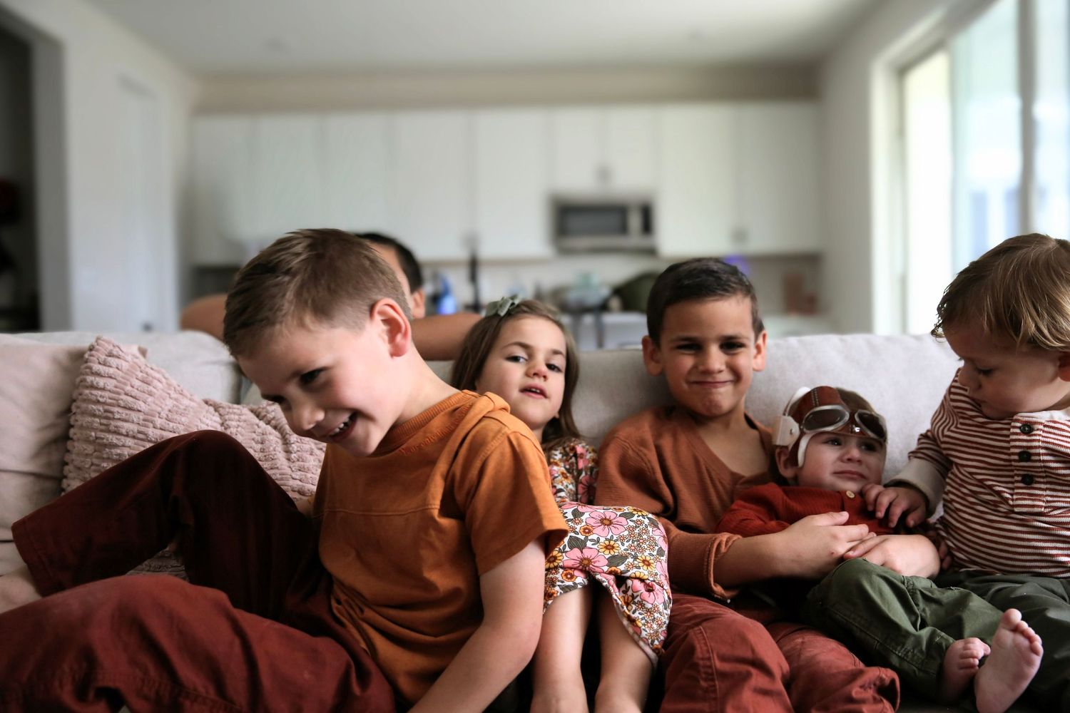 Siblings having fun on the couch.
