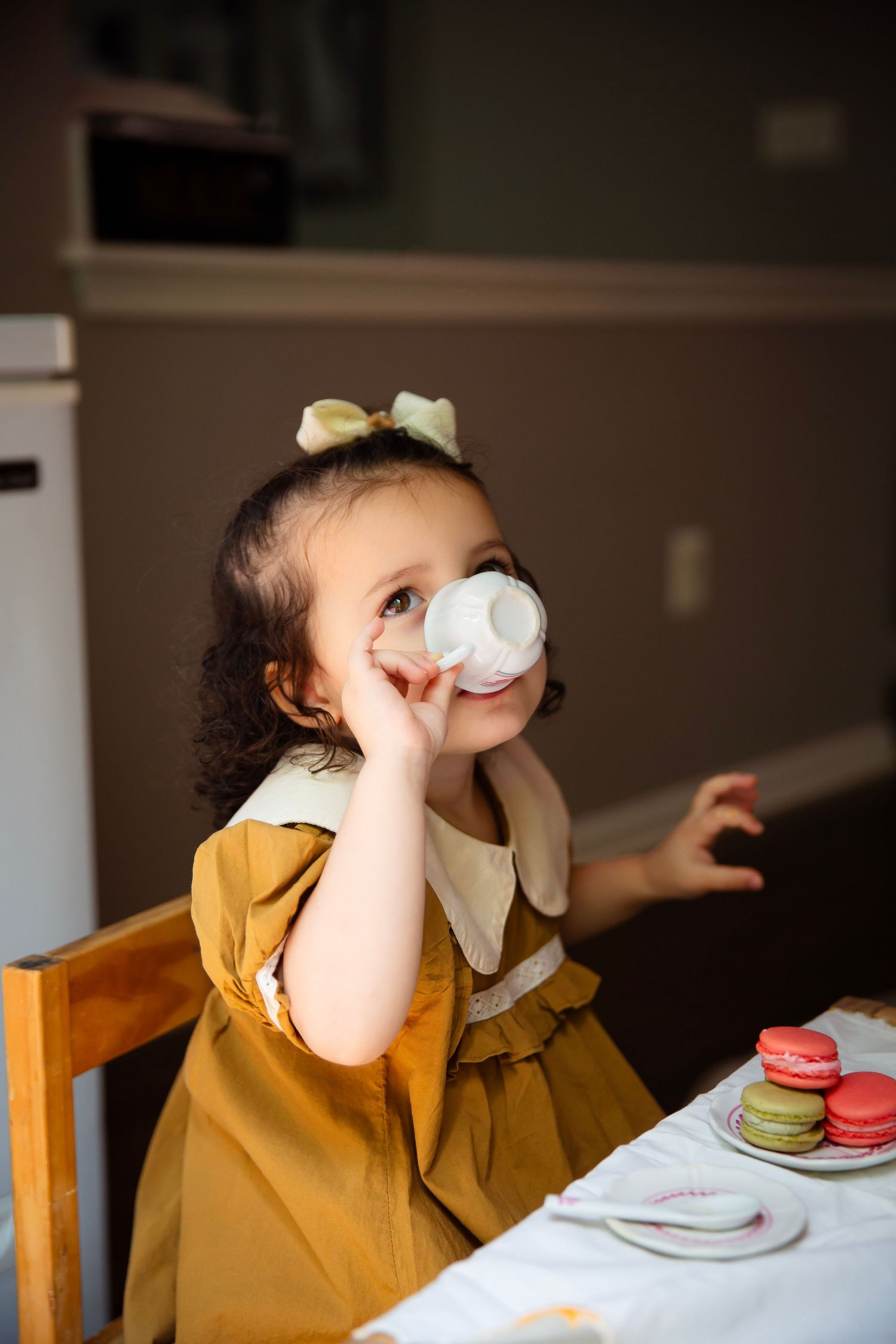 toddler girl with play tea set