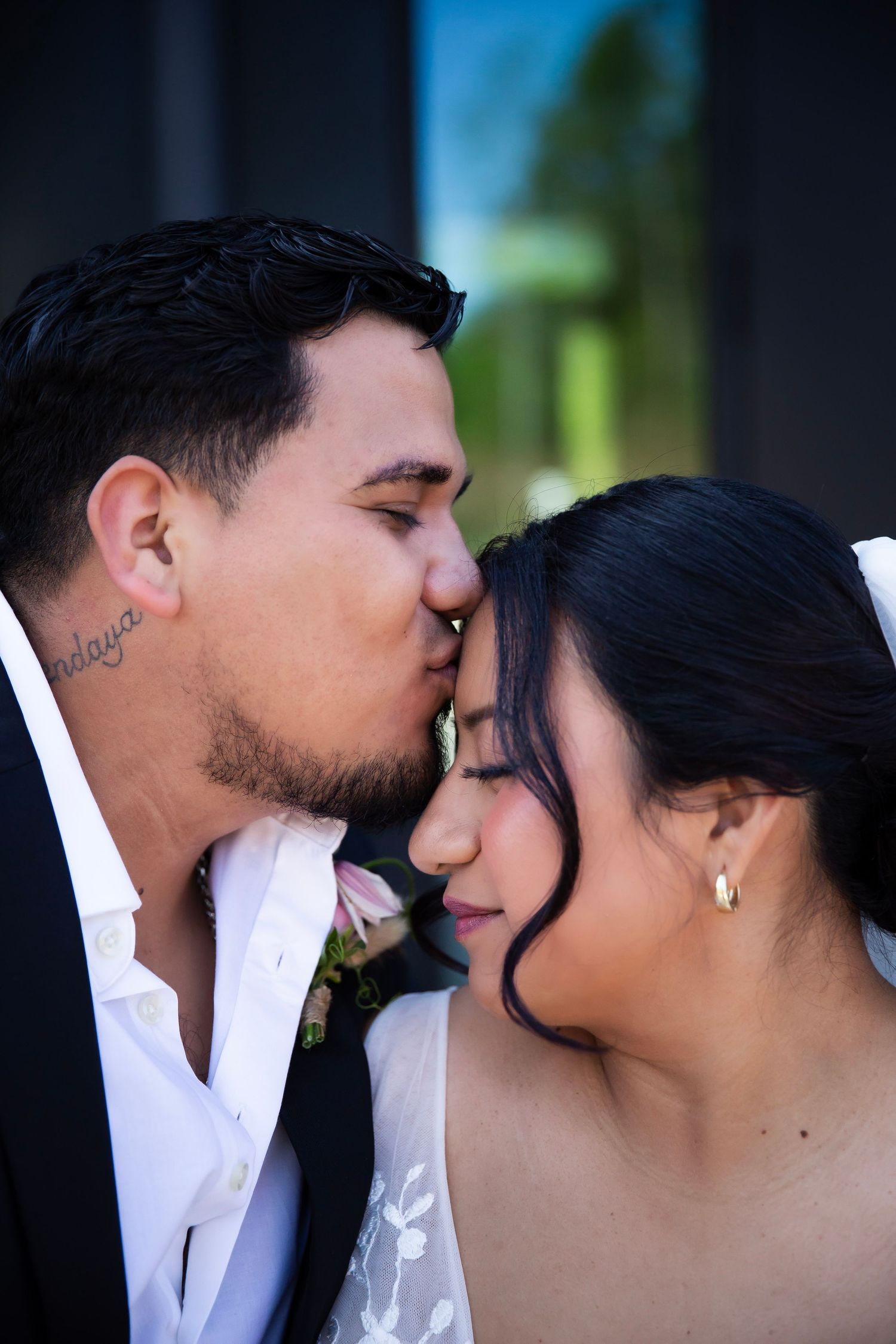Groom kissing brides forehead