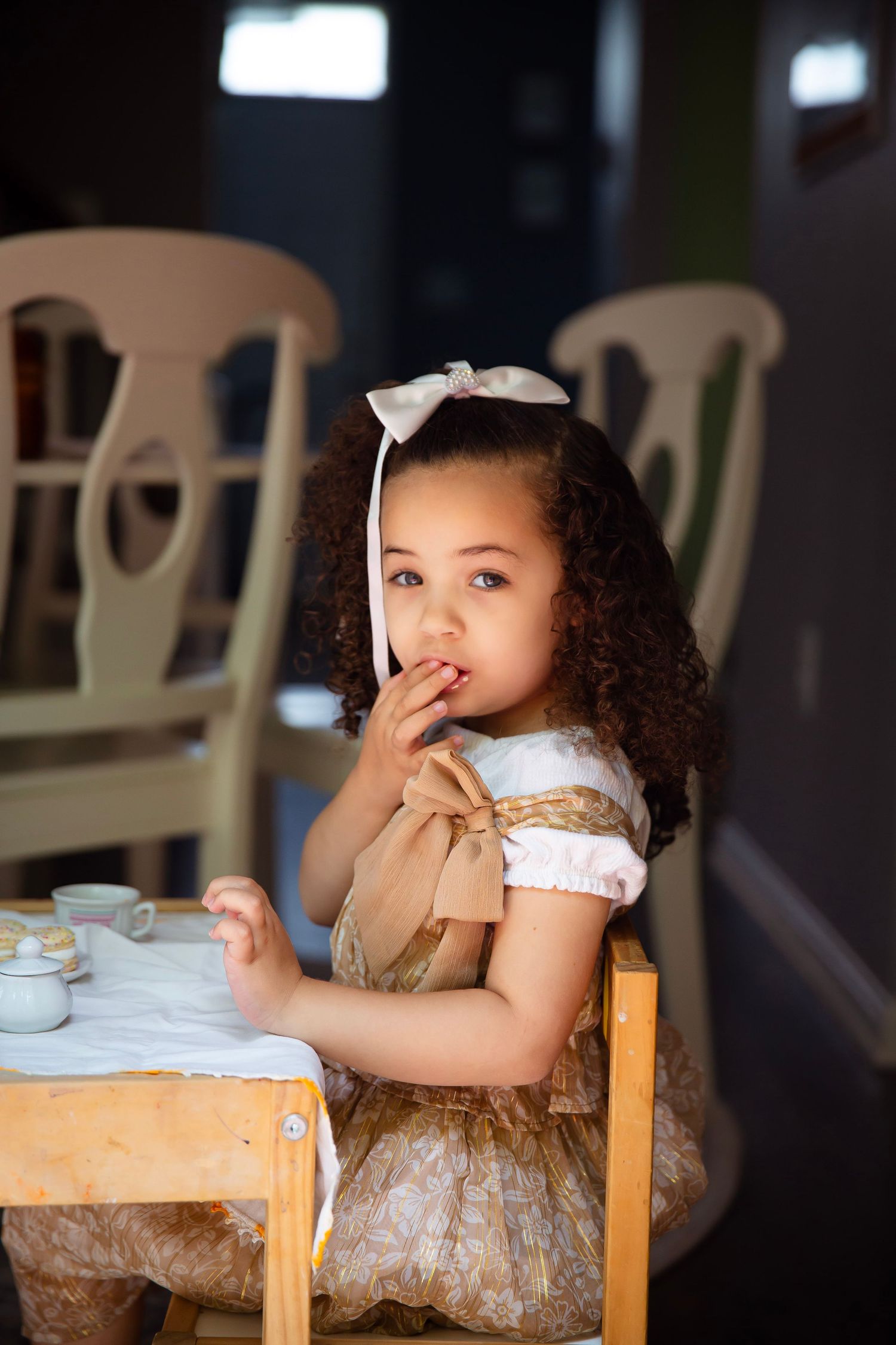 toddler girl with play tea set
