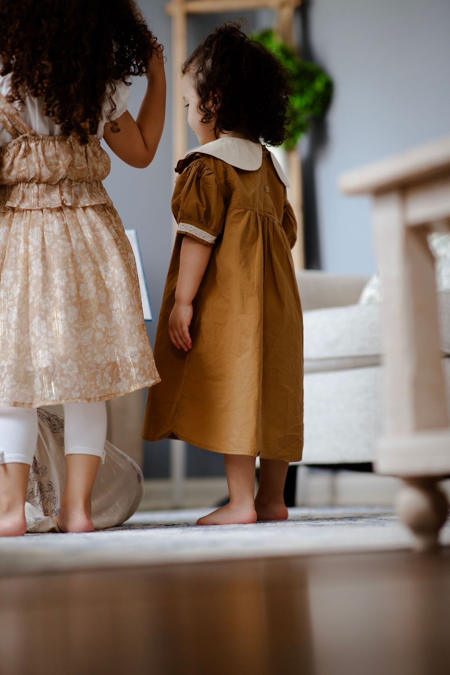 Mom and daughters huddle over a book