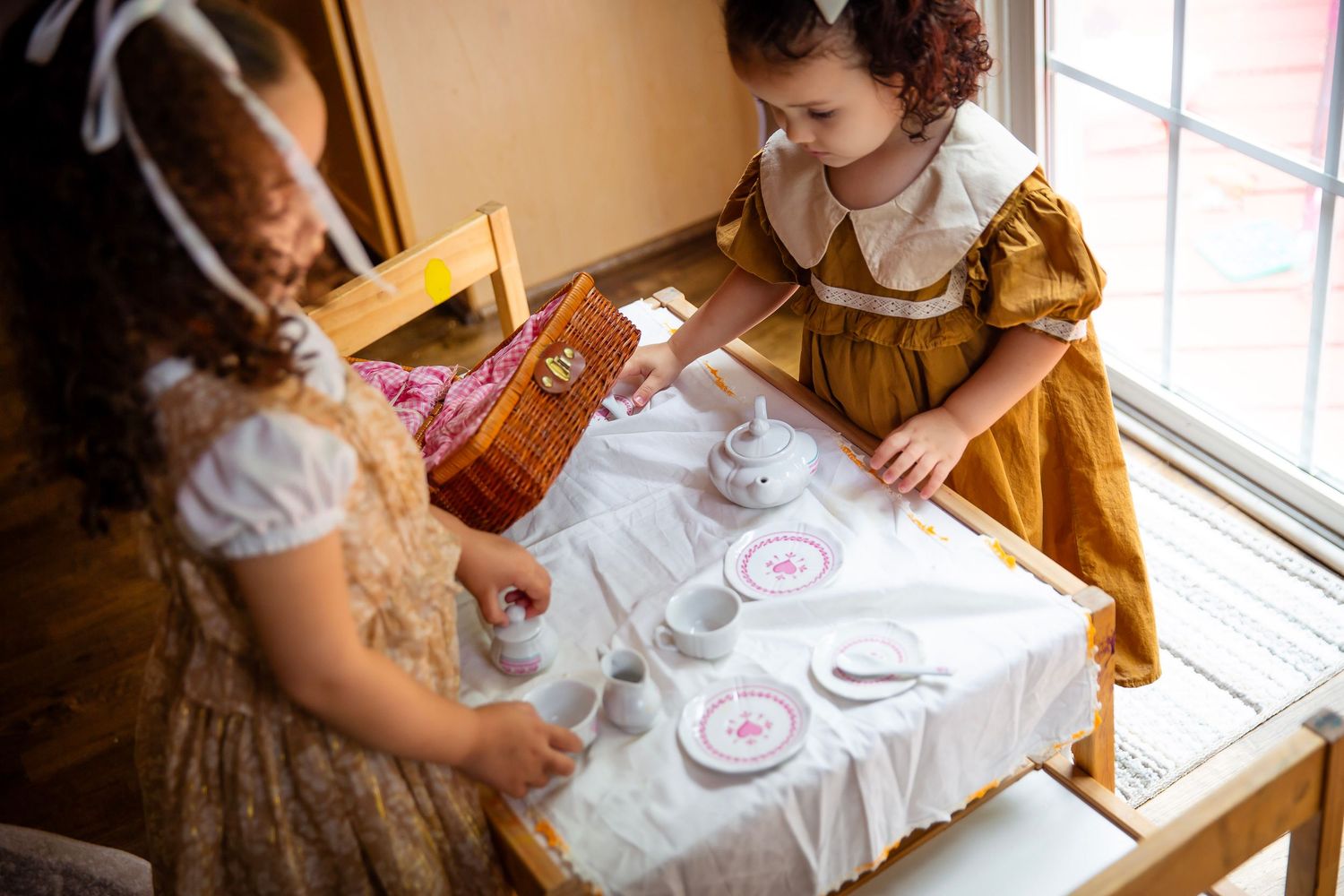 Sisters with play tea set