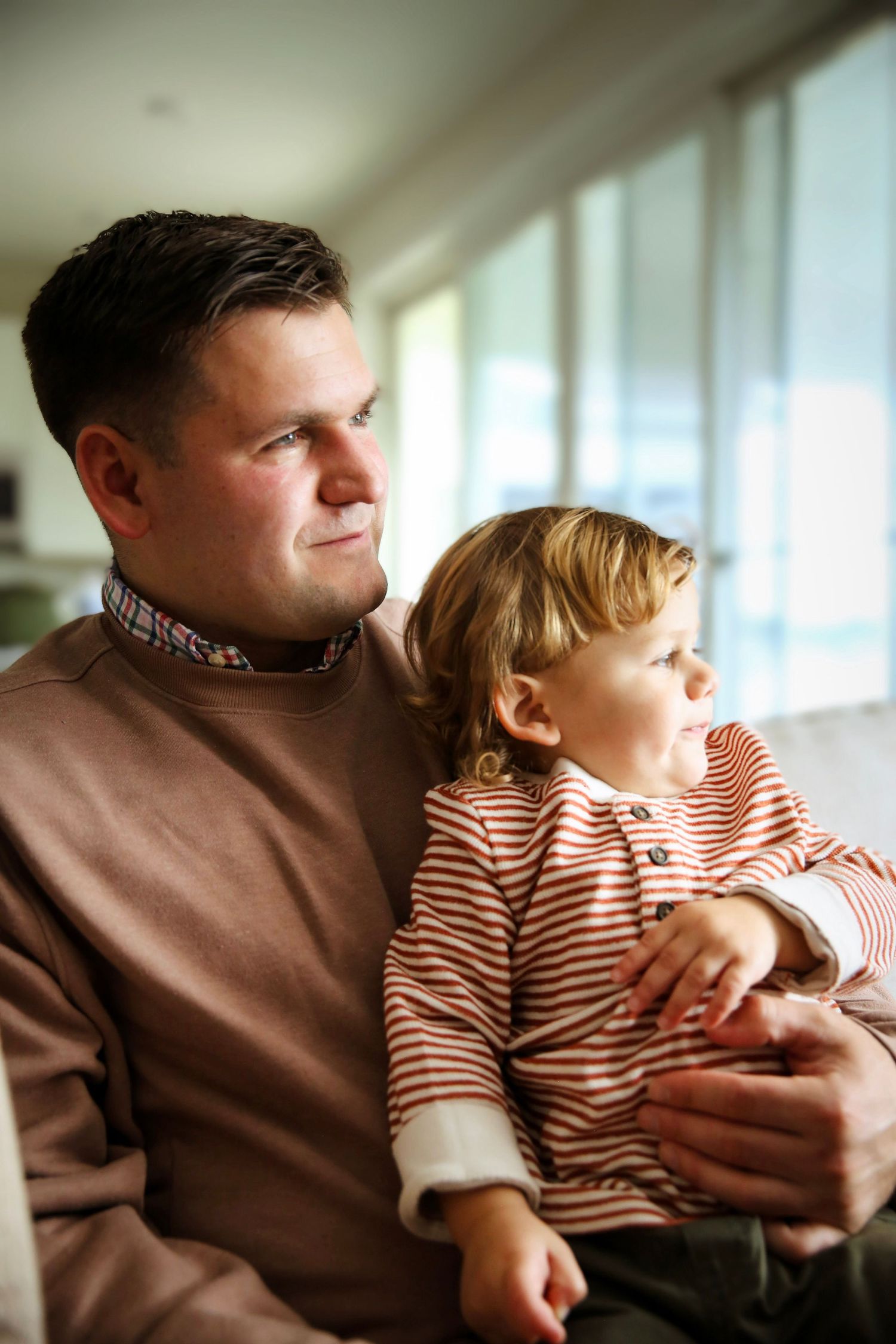 Dad and toddler son share a moment.