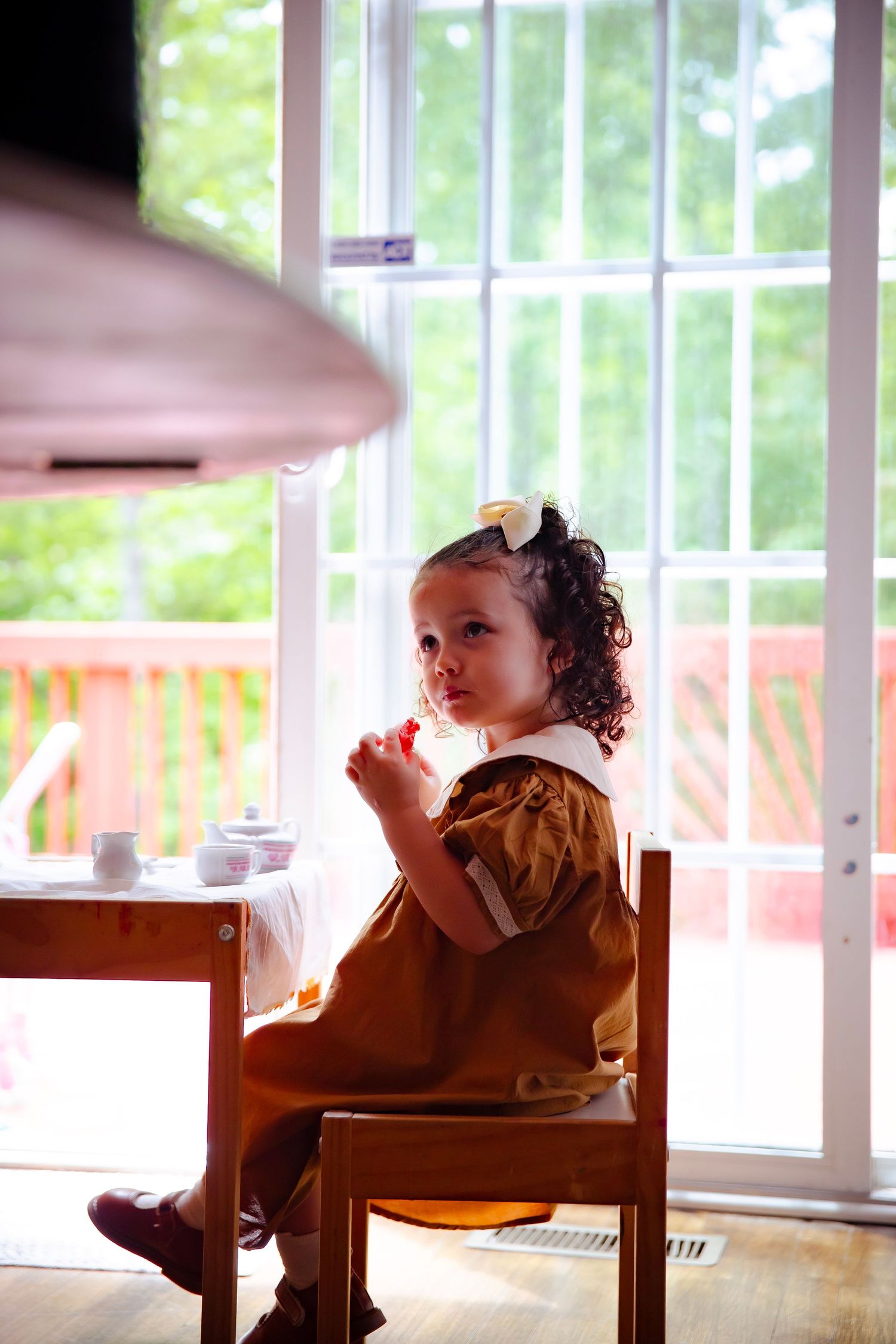 Little girl sitting at her mini table set