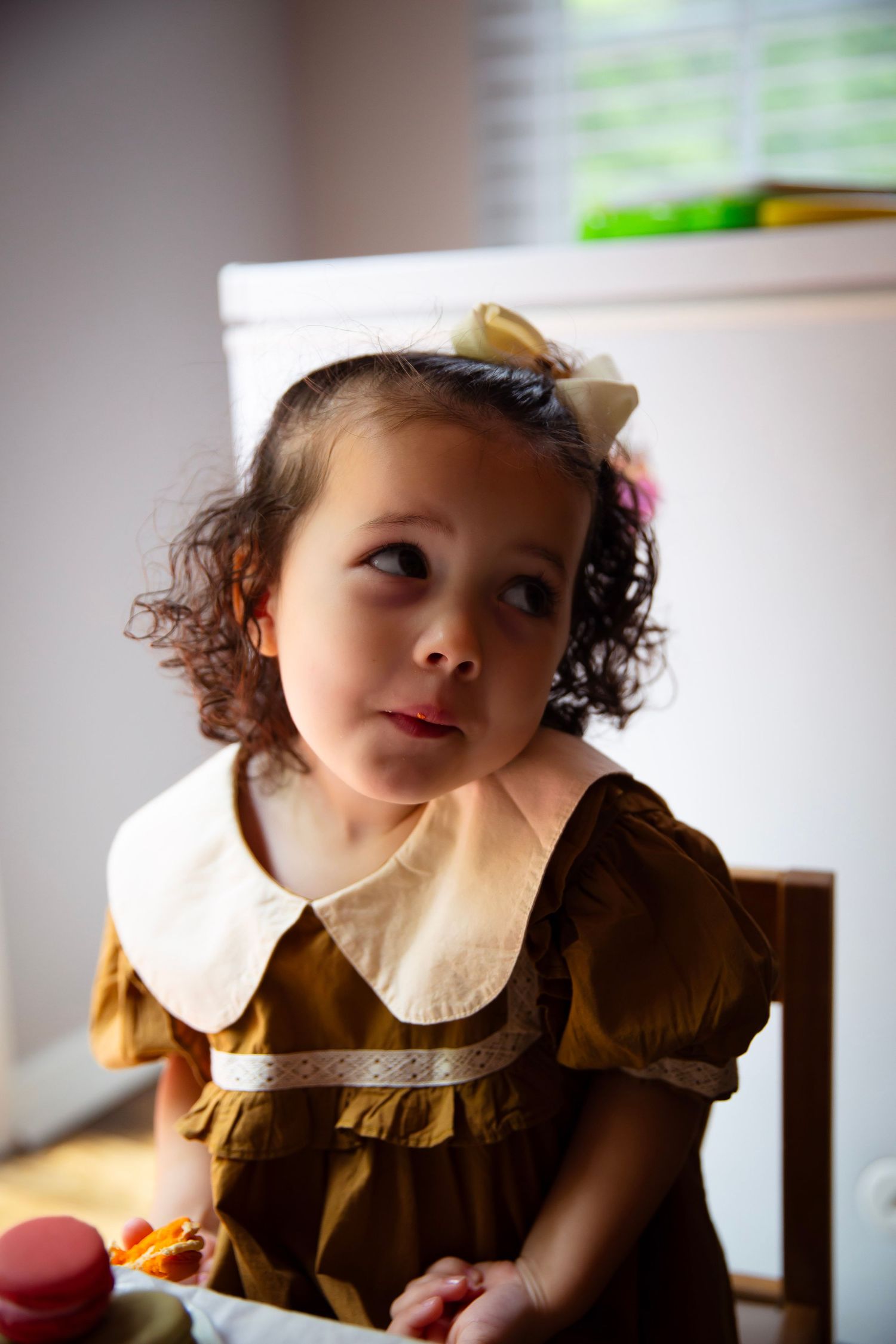 Toddler girl with play tea set