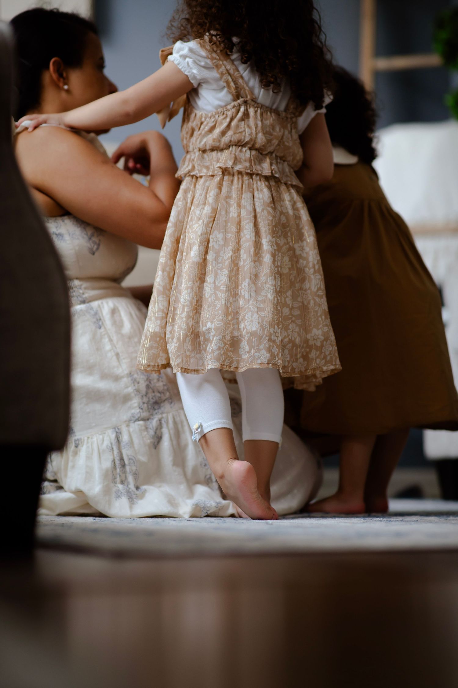 Mom and daughters huddle over a book
