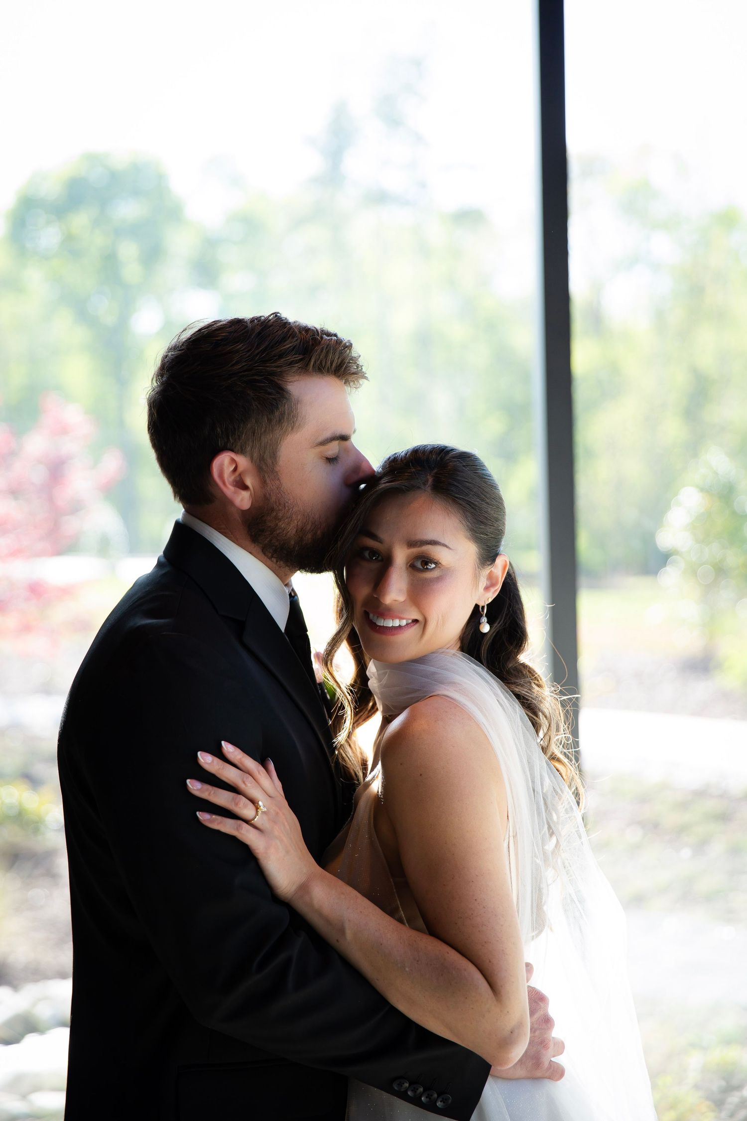 Bride leaning against groom in comfort