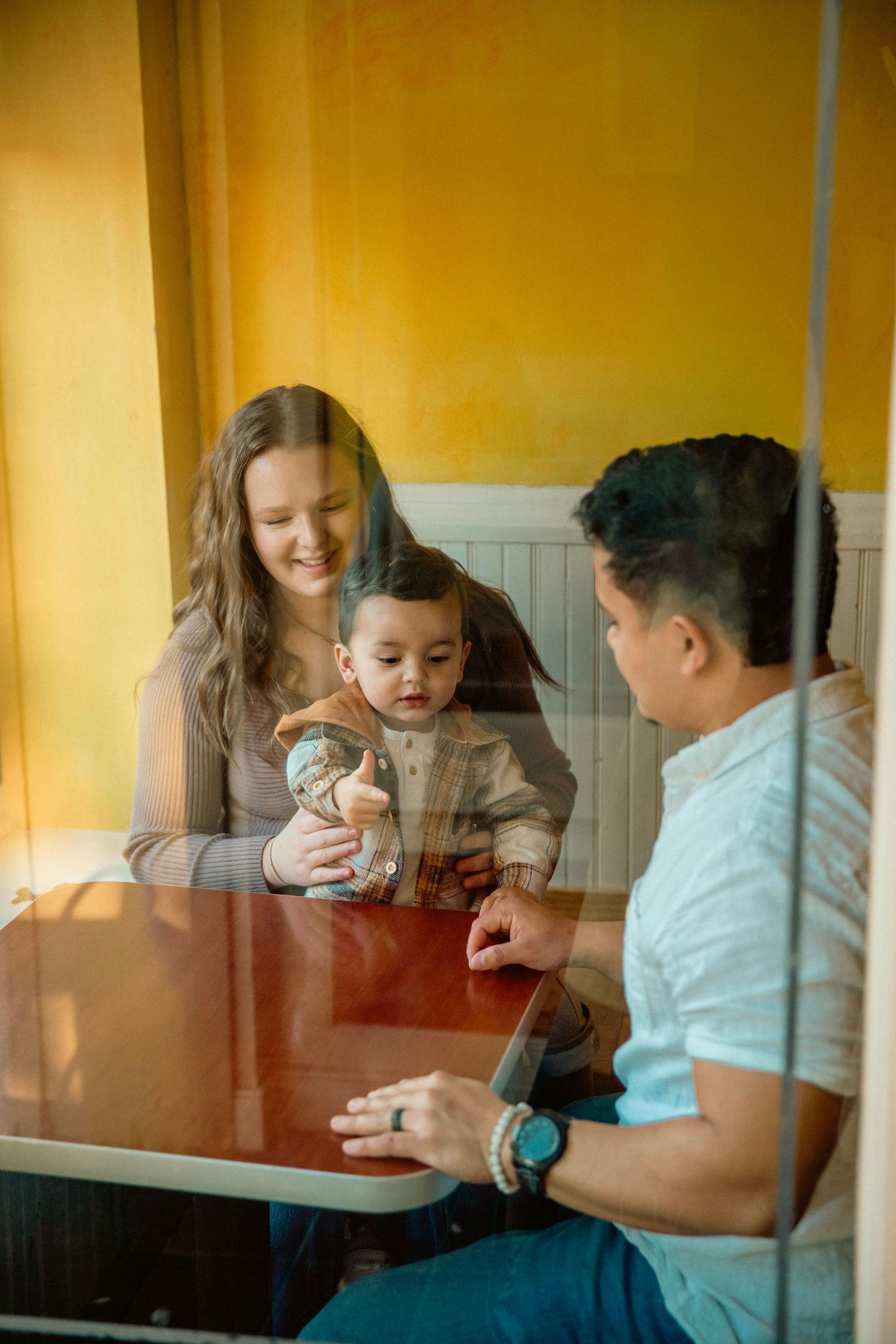 Film style photo of small family in a cafe