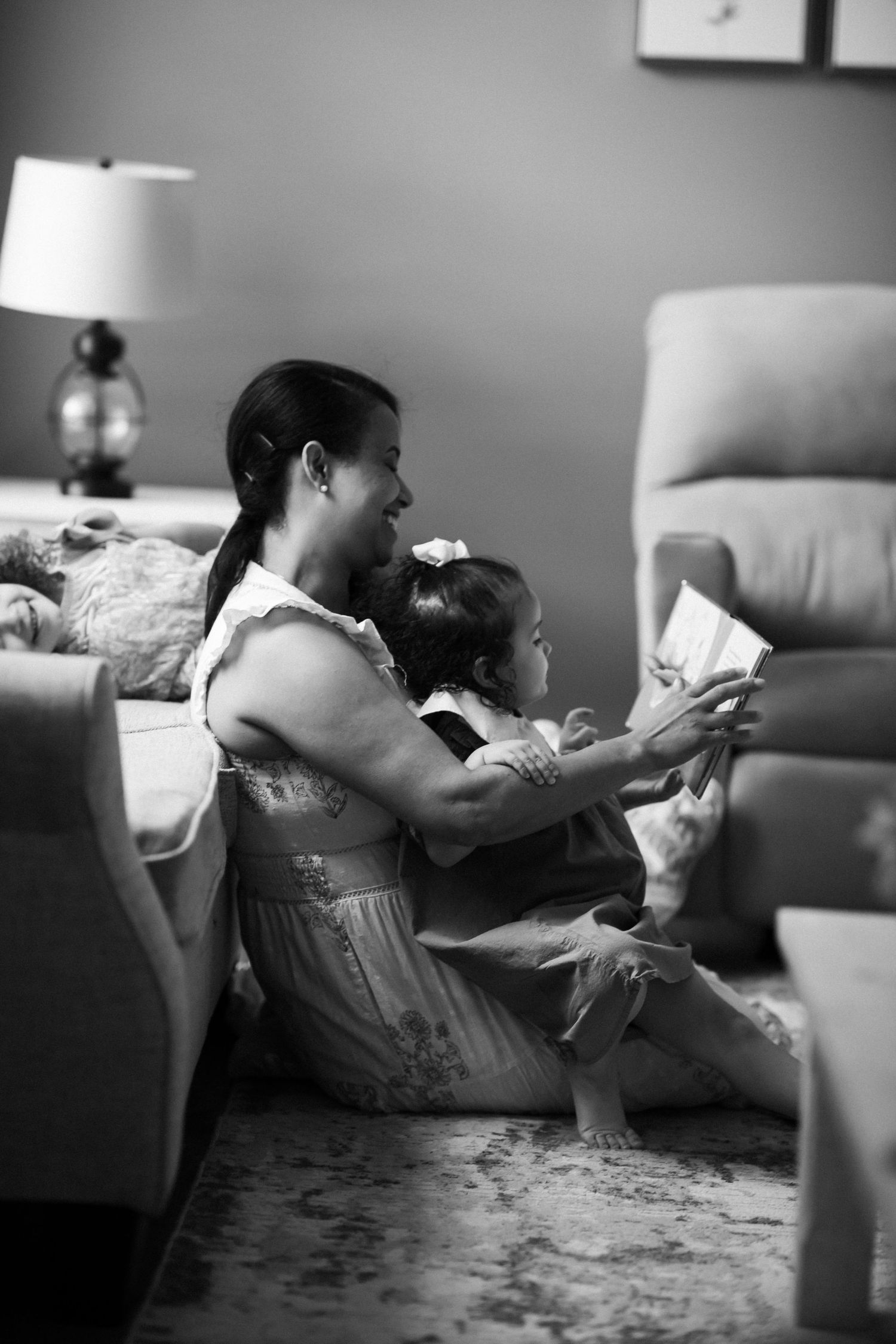 Mom and daughters huddle over a book