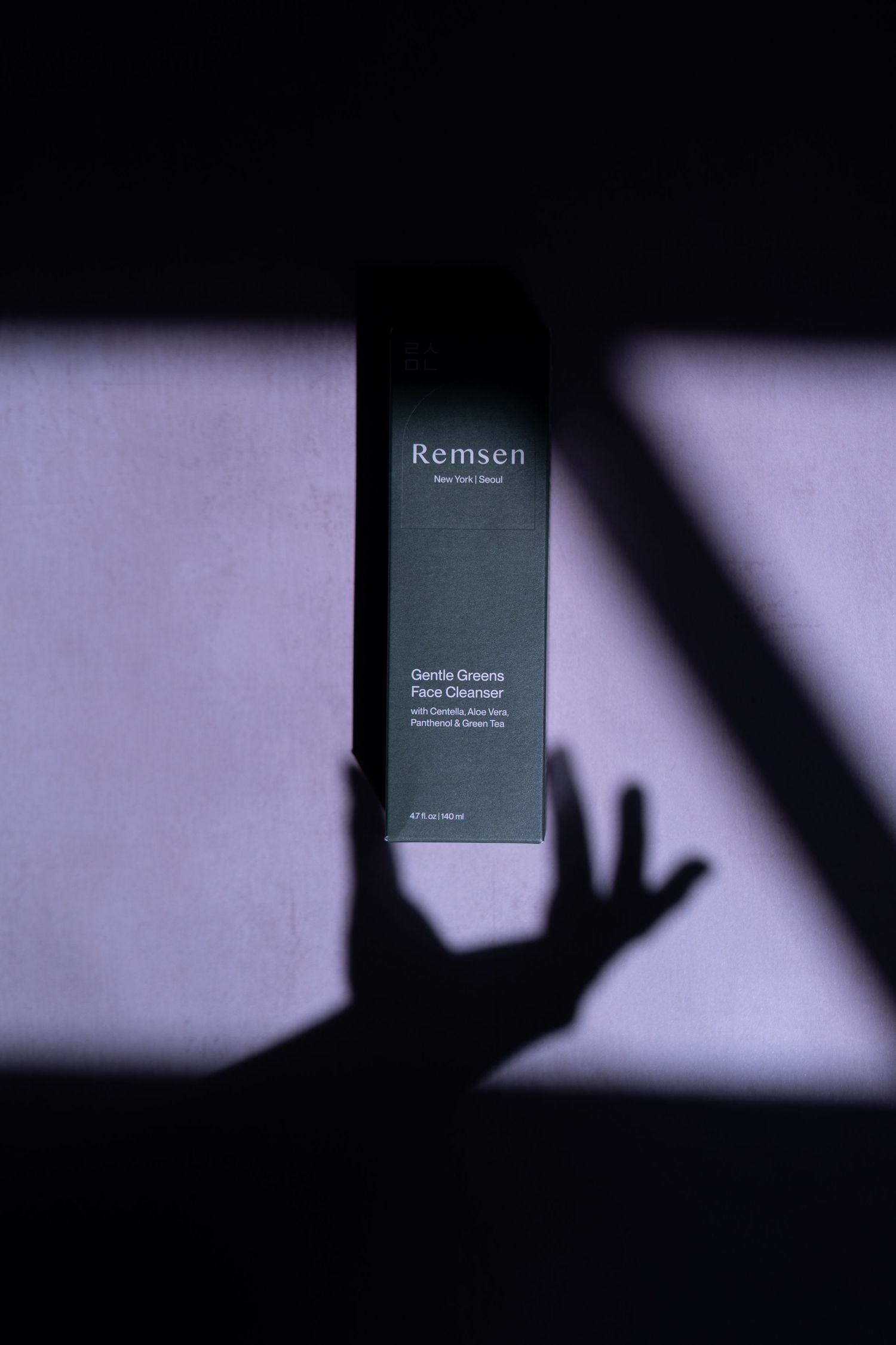 Remsen face cream under shadow hand