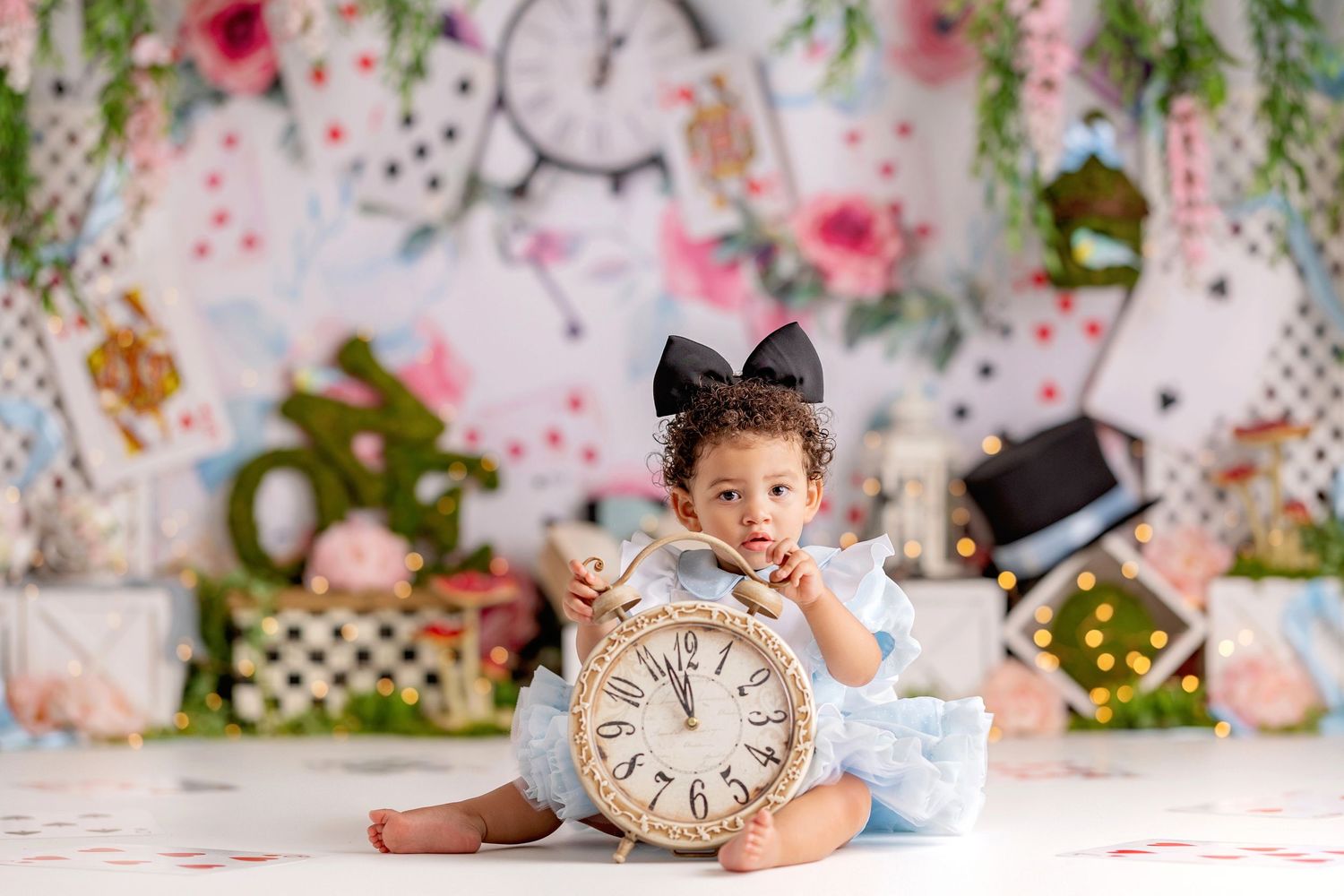 Baby girl first birthday Alice in Wonderland themed cake smash with clock and tea party props in Vacaville California