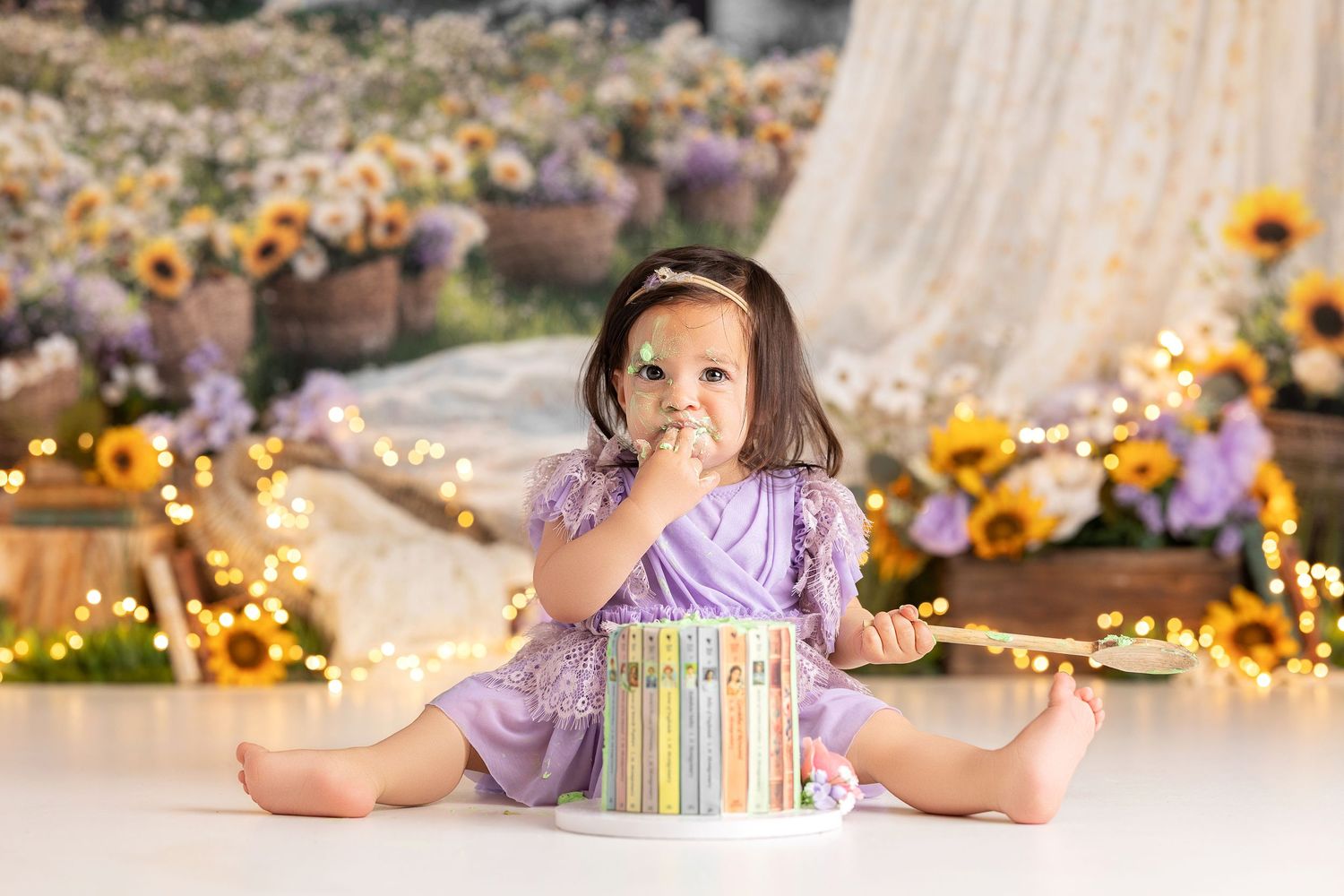 Baby girl first birthday floral spring cake smash with lavender dress and sunflower backdrop in Vacaville California
