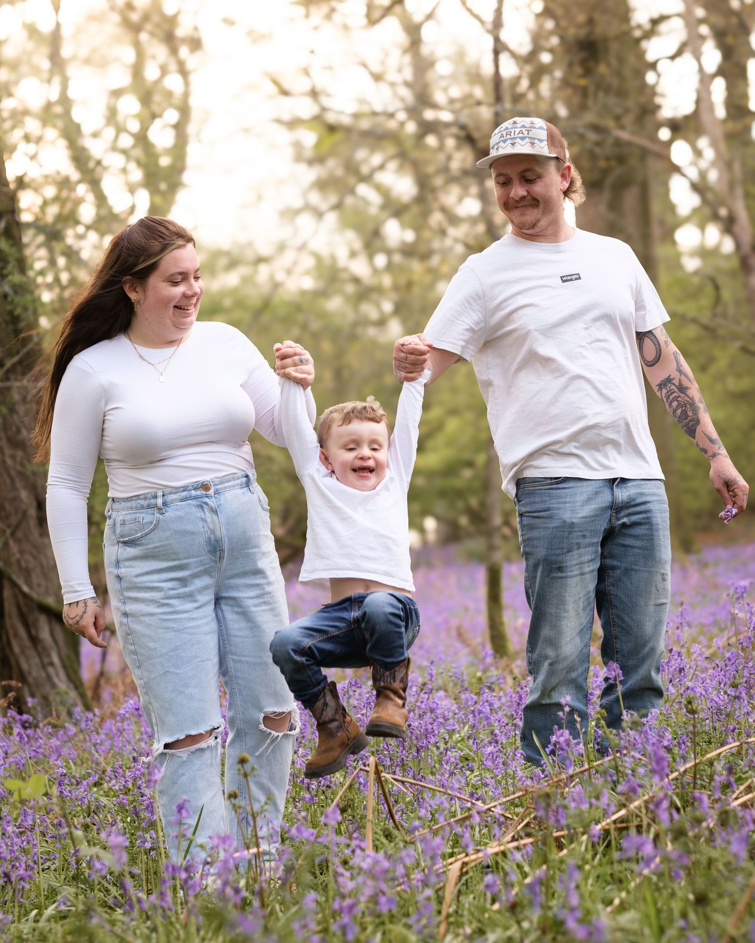 outdoor family photoshoot amongst bluebells capturing moments and laughs happy family Newbury photographer