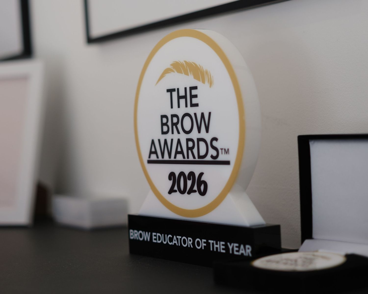 The Brow Awards 2026 Brow Educator of the Year trophy displayed on a desk.