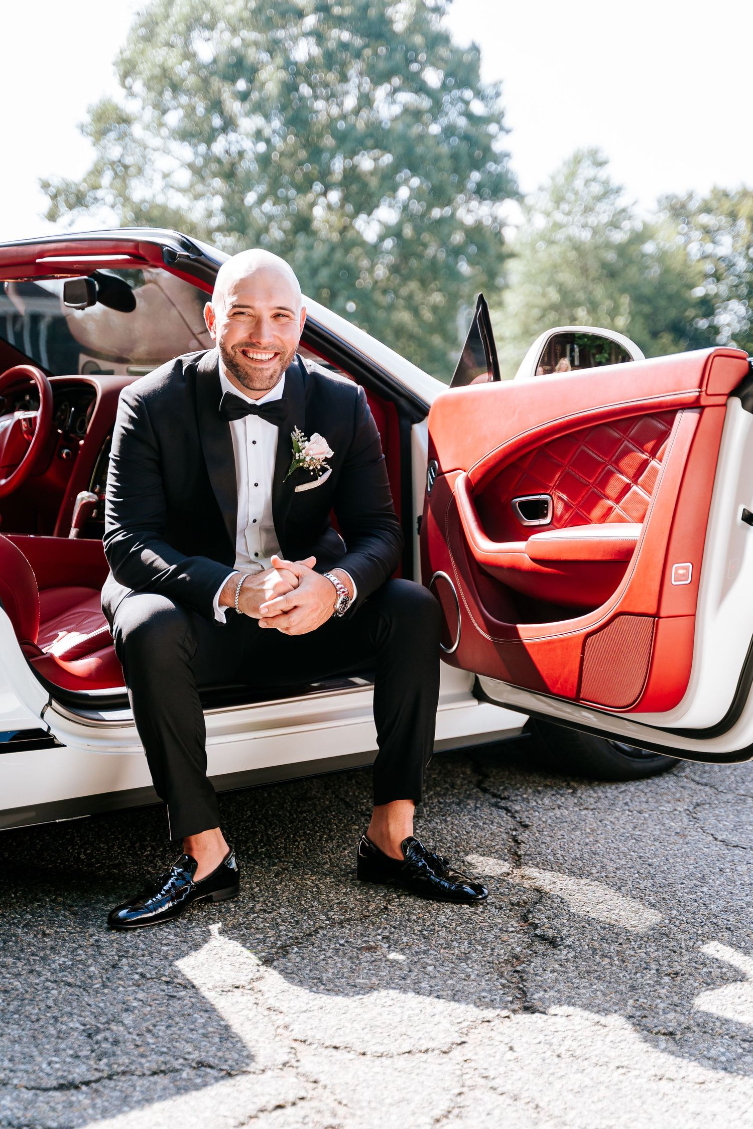 groom wedding photos with luxury car