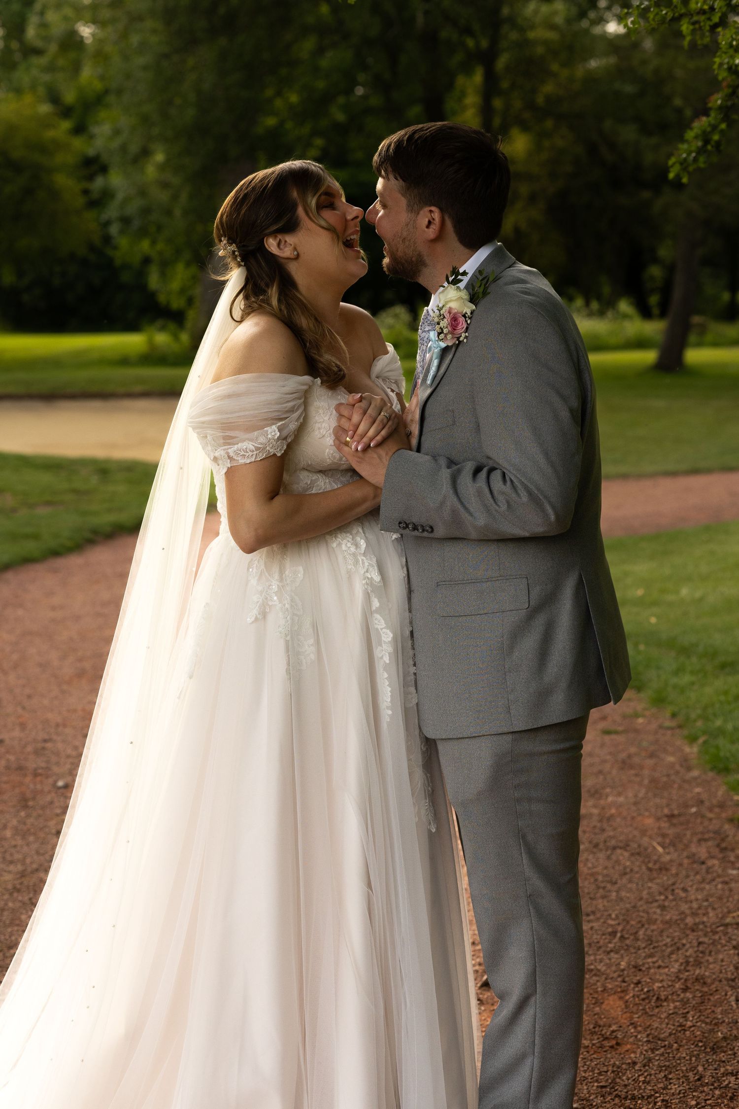 Bride and groom holding each other closely and laughing