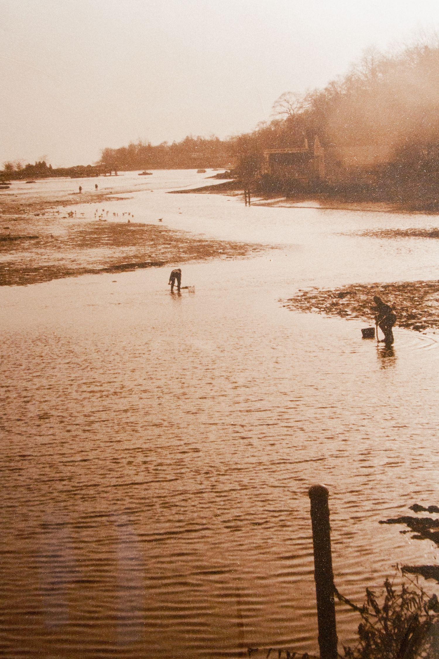 black and white sepia-toned silver gelatin print of Southport Ct. harbor at low tide in evening light