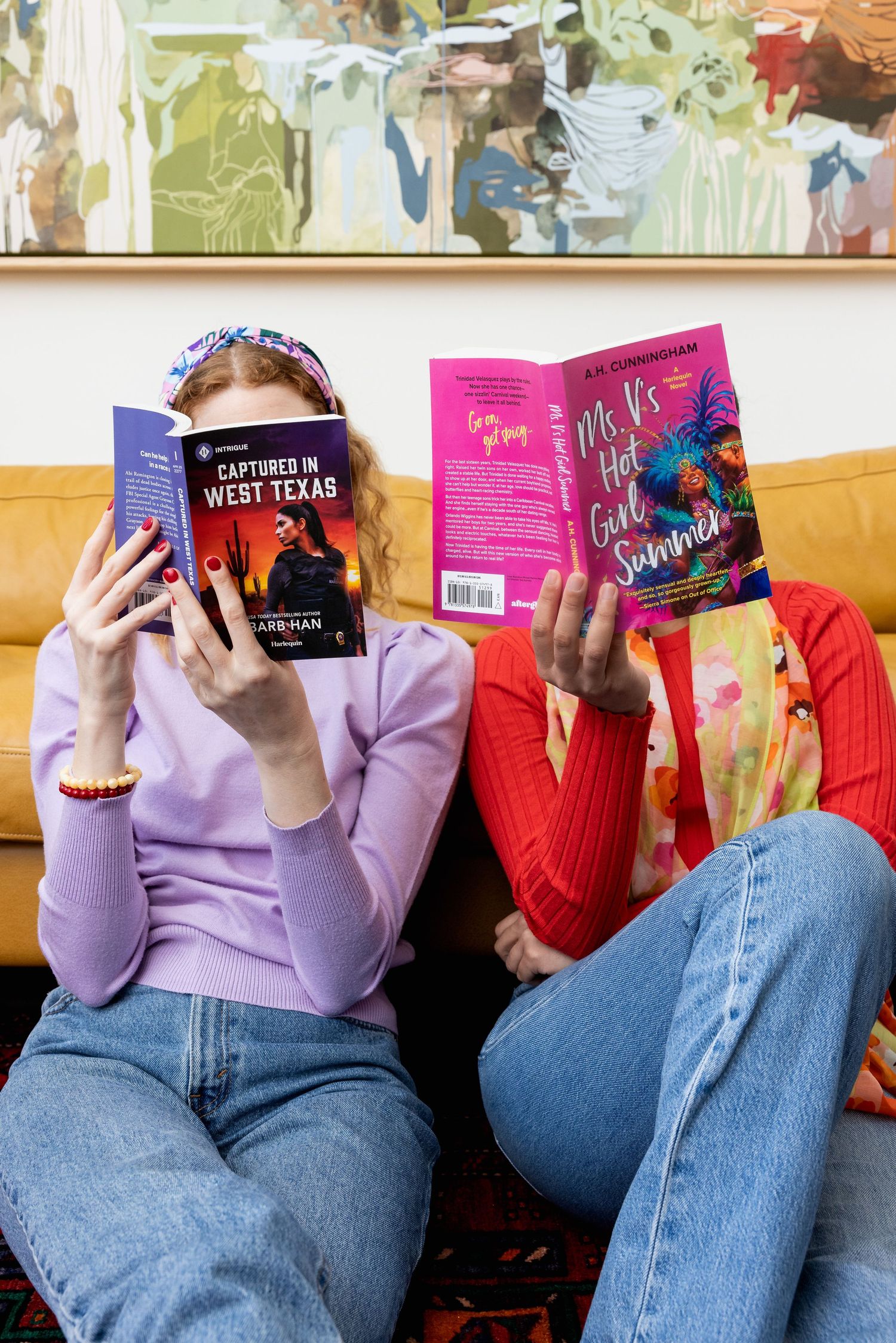 Two young people in bright clothing read romance novels side by side on the couch. Colorful, lifestyle, books, romance, Harlequin.