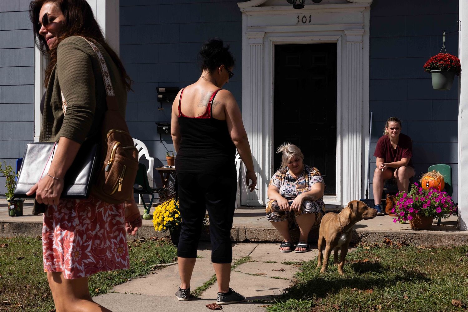 A group of people walk outside a safe house for people recovering from addiction, a documentary photo project for Missouri Photo Workshop