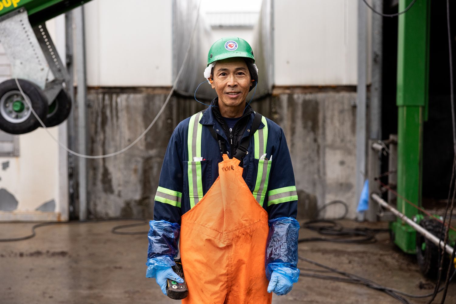 A Vietnamese immigrant farm worker on the job in an industrial setting for a documentary style commercial photoshoot for a union