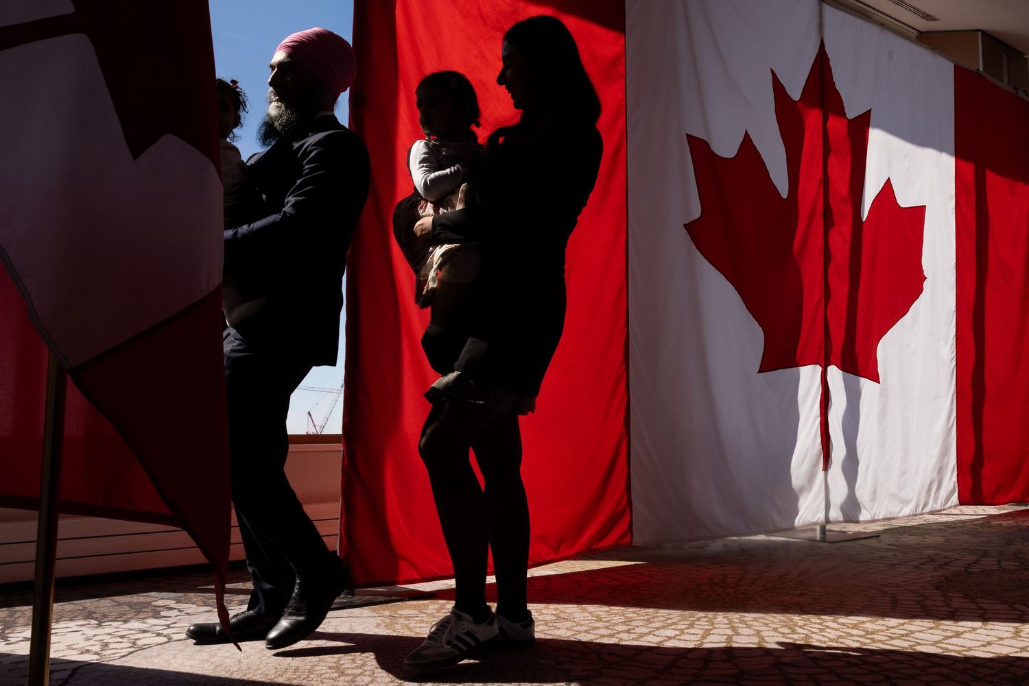A political leader walks by a Canadian flag during an election, documentary style photography patriotic