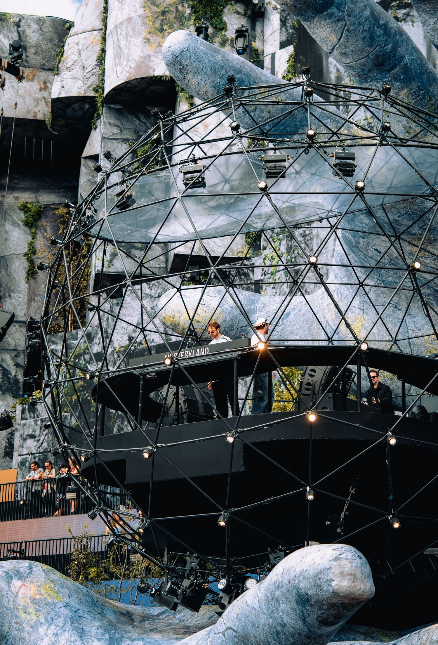 DJs performing inside a geodesic dome sphere stage structure at Mysteryland festival during daytime.