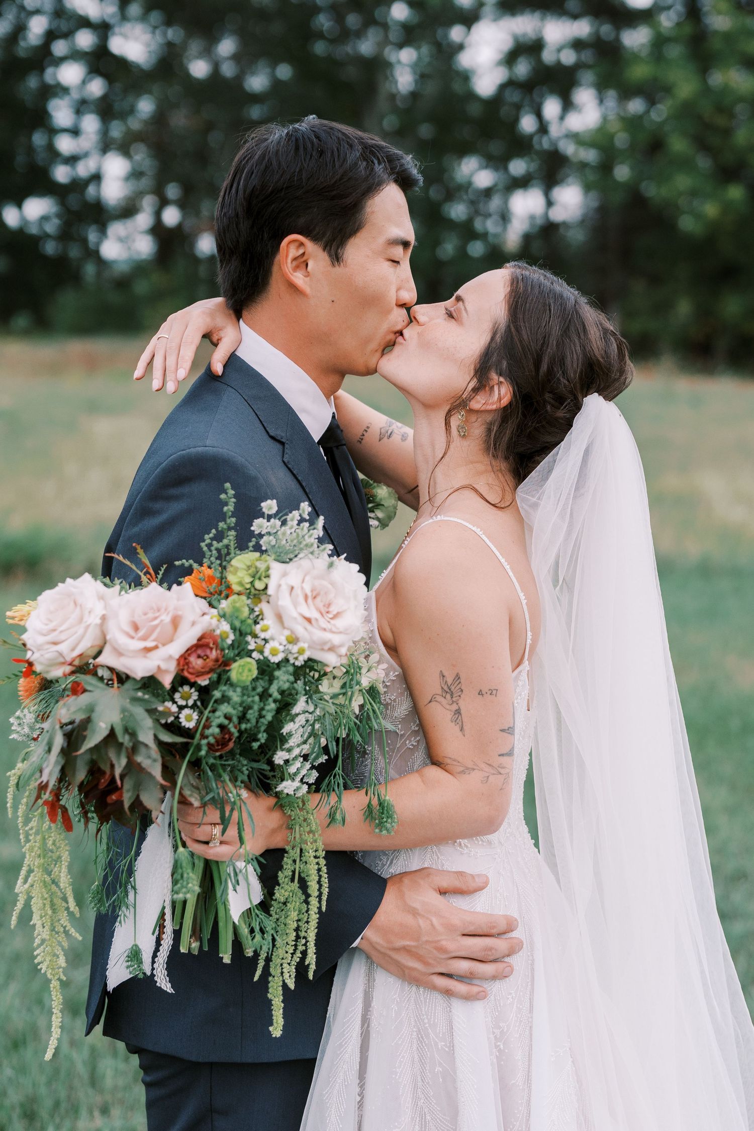 A couple shares tender moments during their wedding photoshoot in a natural outdoor setting.