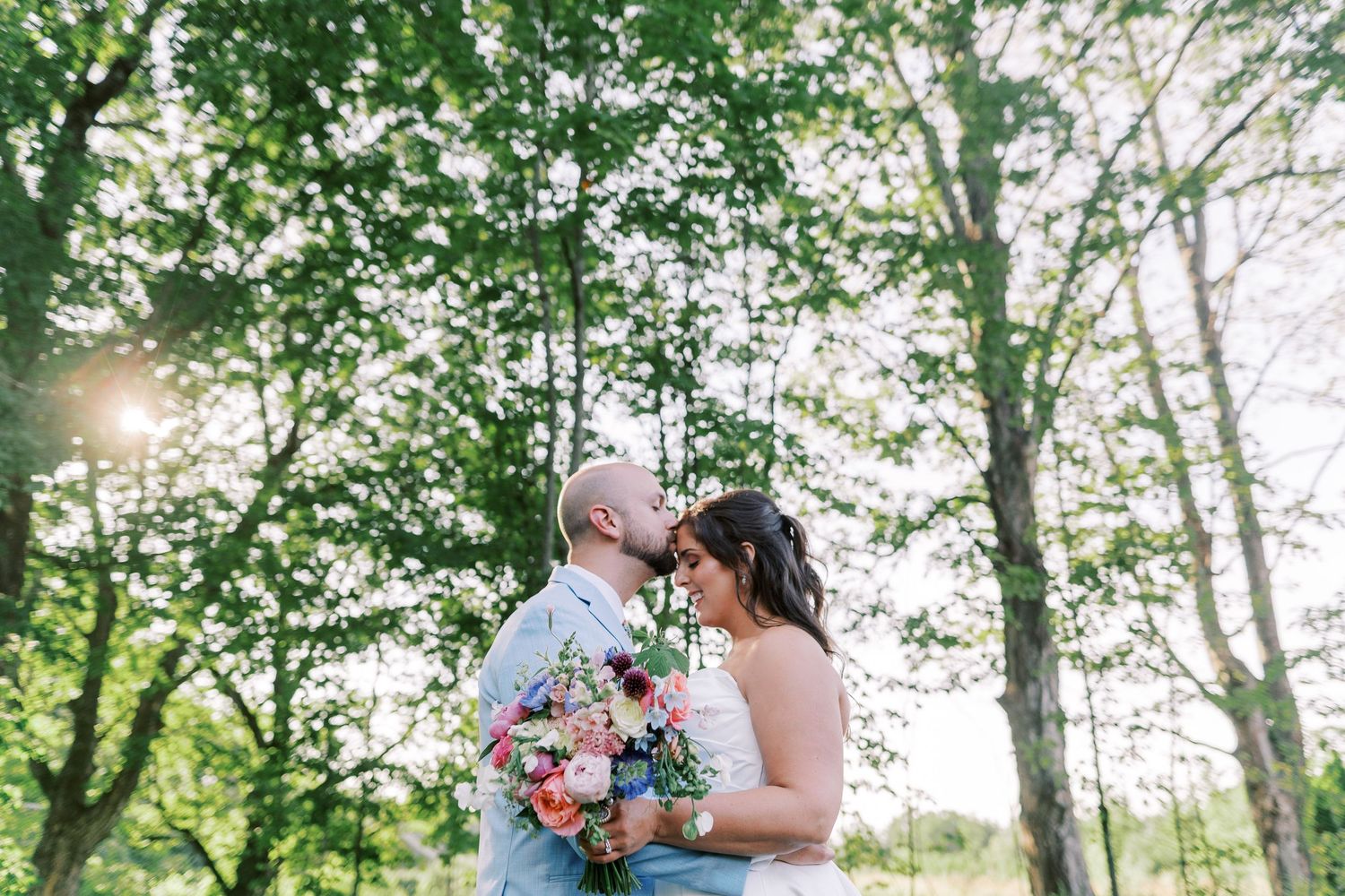Couple shares tender moments across six romantic forest wedding photos surrounded by lush green trees and natural light.