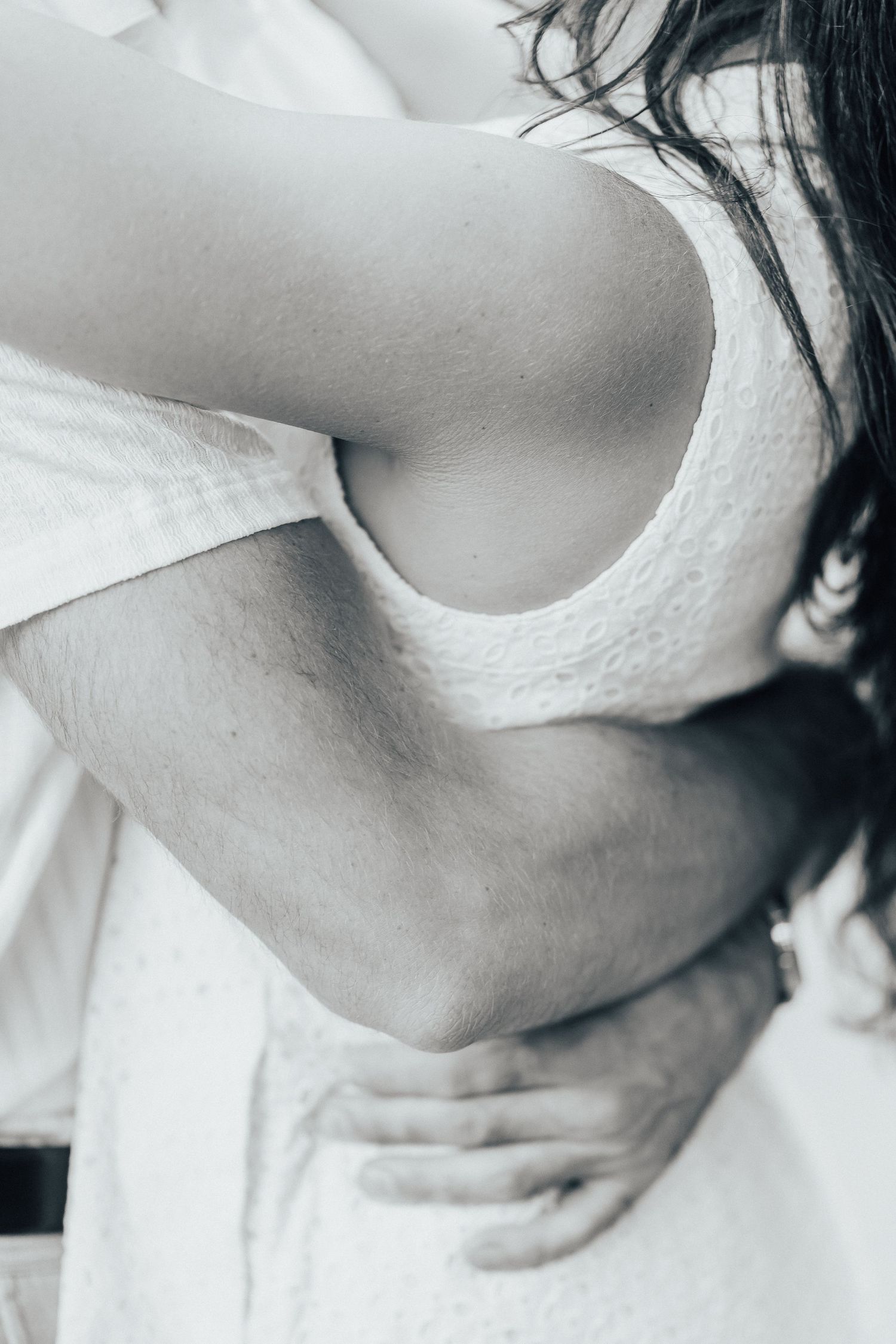 Artistic black and white close-up showing neck and shoulder details.