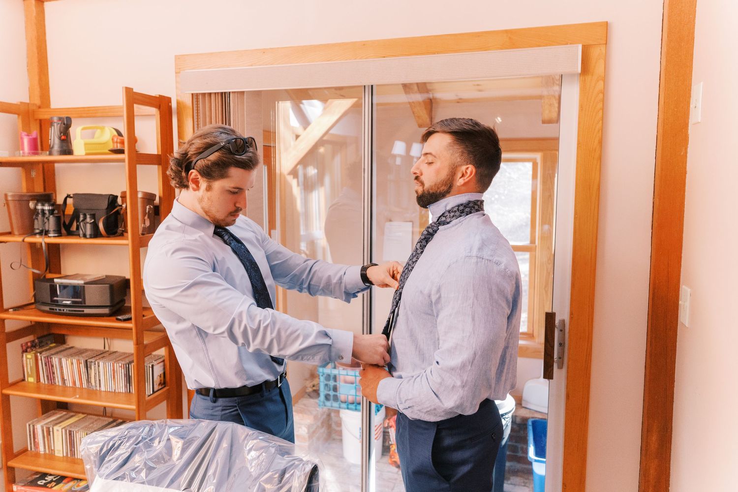 Two people in business attire demonstrate self-defense moves in a professional office setting.
