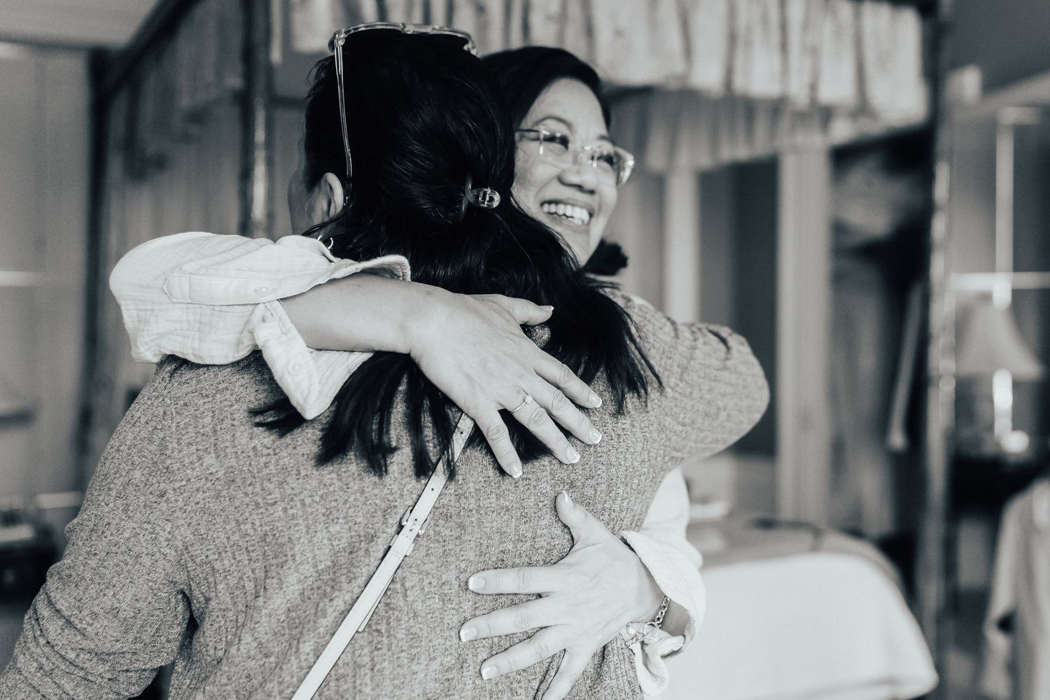 Black and white candid moments of joyful embraces and celebrations.