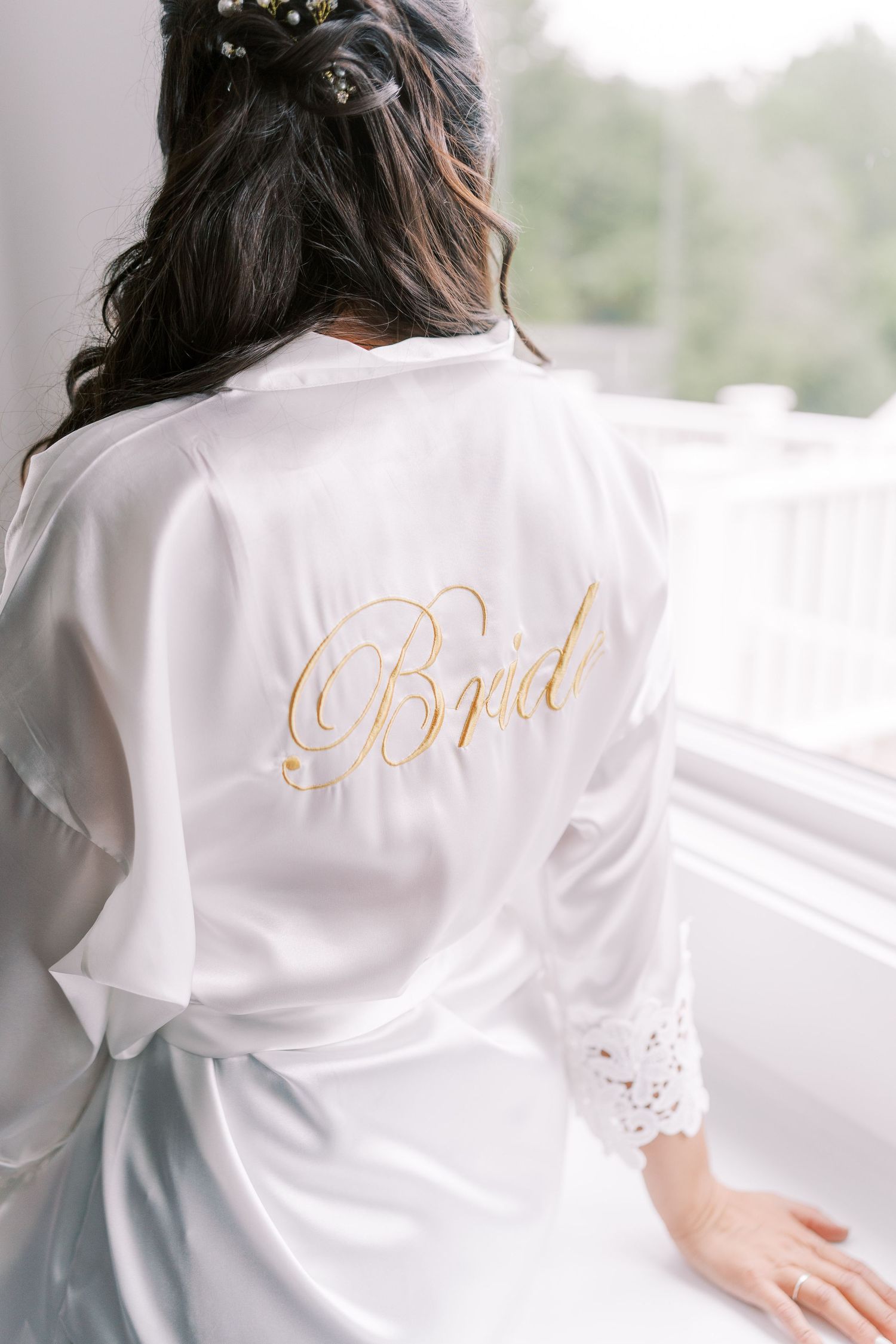 White silk robe with gold 'Bride' text embroidered on the back.