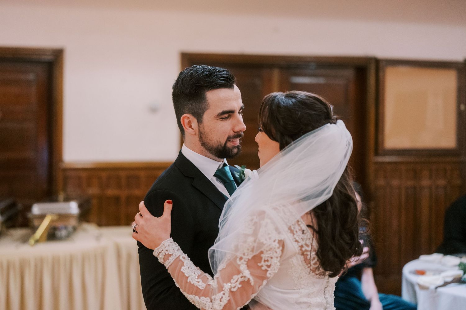 Bride and groom share an intimate moment during their wedding reception.