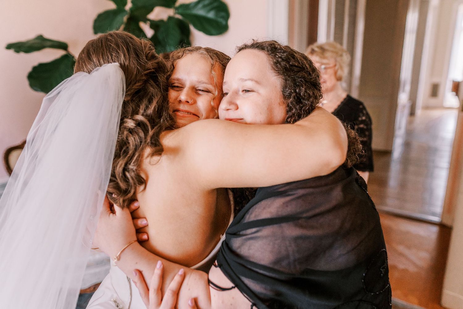 A tender embrace shared between wedding attendees during an emotional celebration.
