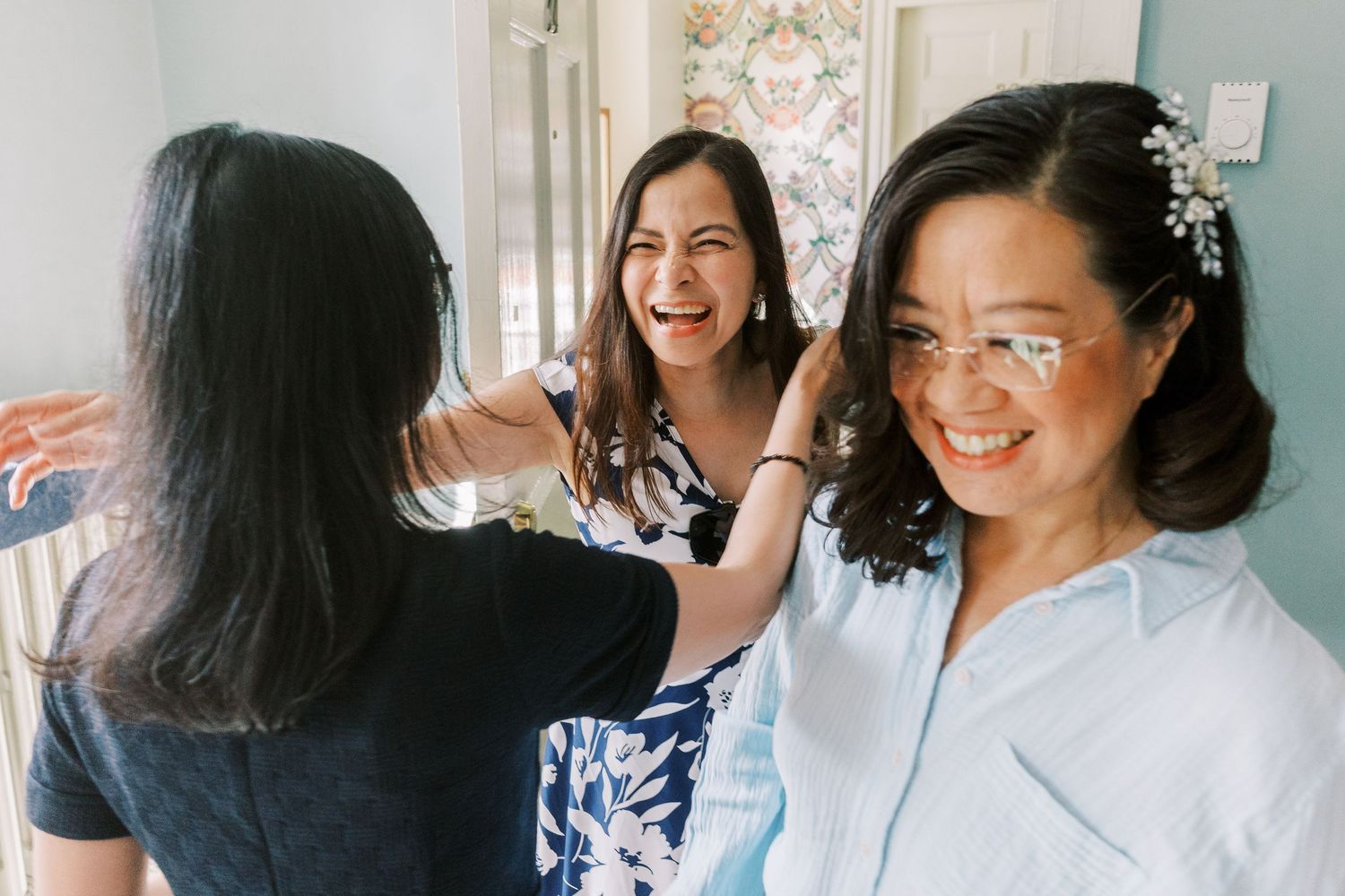A candid black and white photo booth strip showing four different joyful expressions and poses.