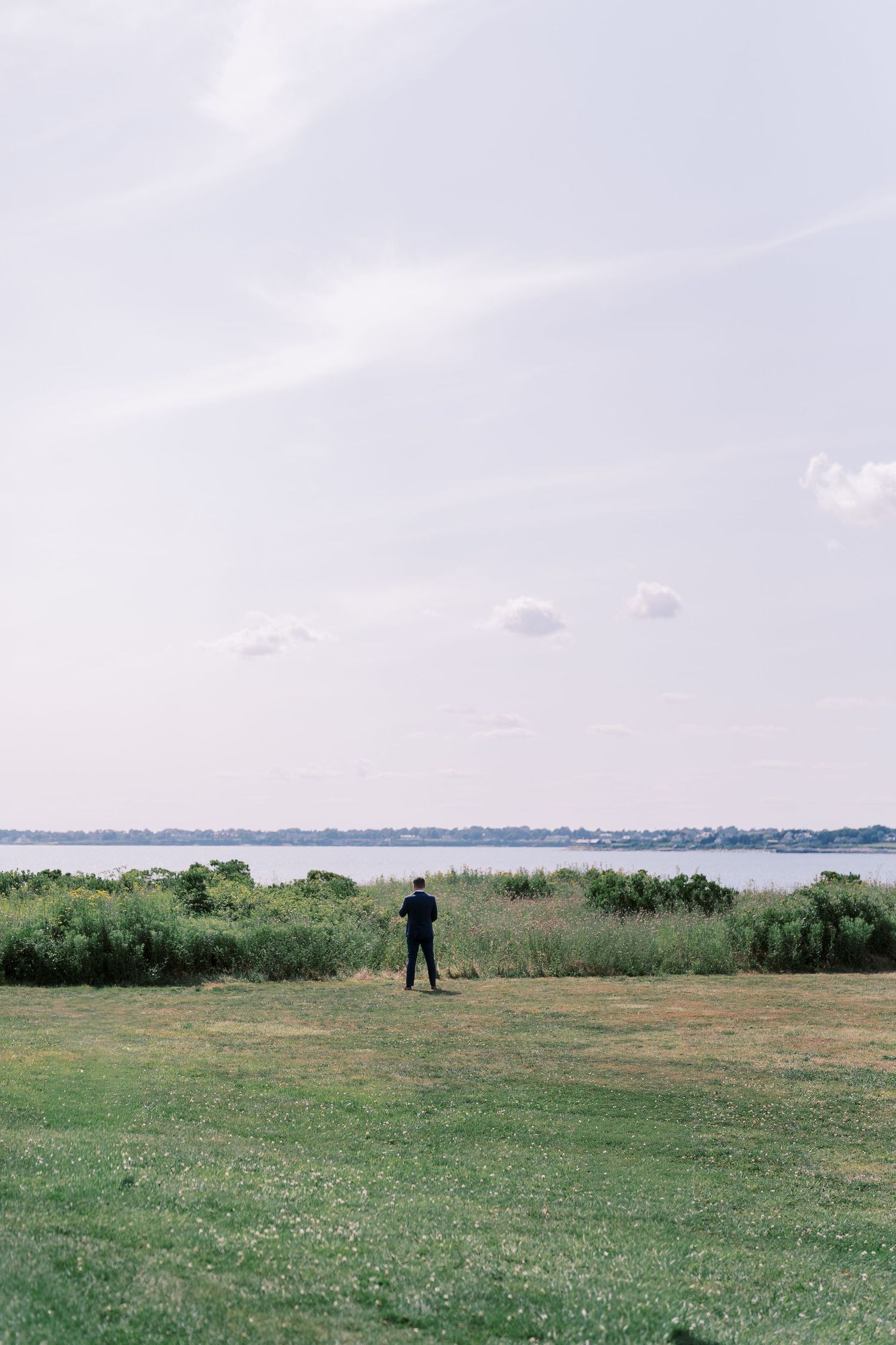 A series of coastal landscape photos showing grassy fields against a cloudy sky and distant water views.