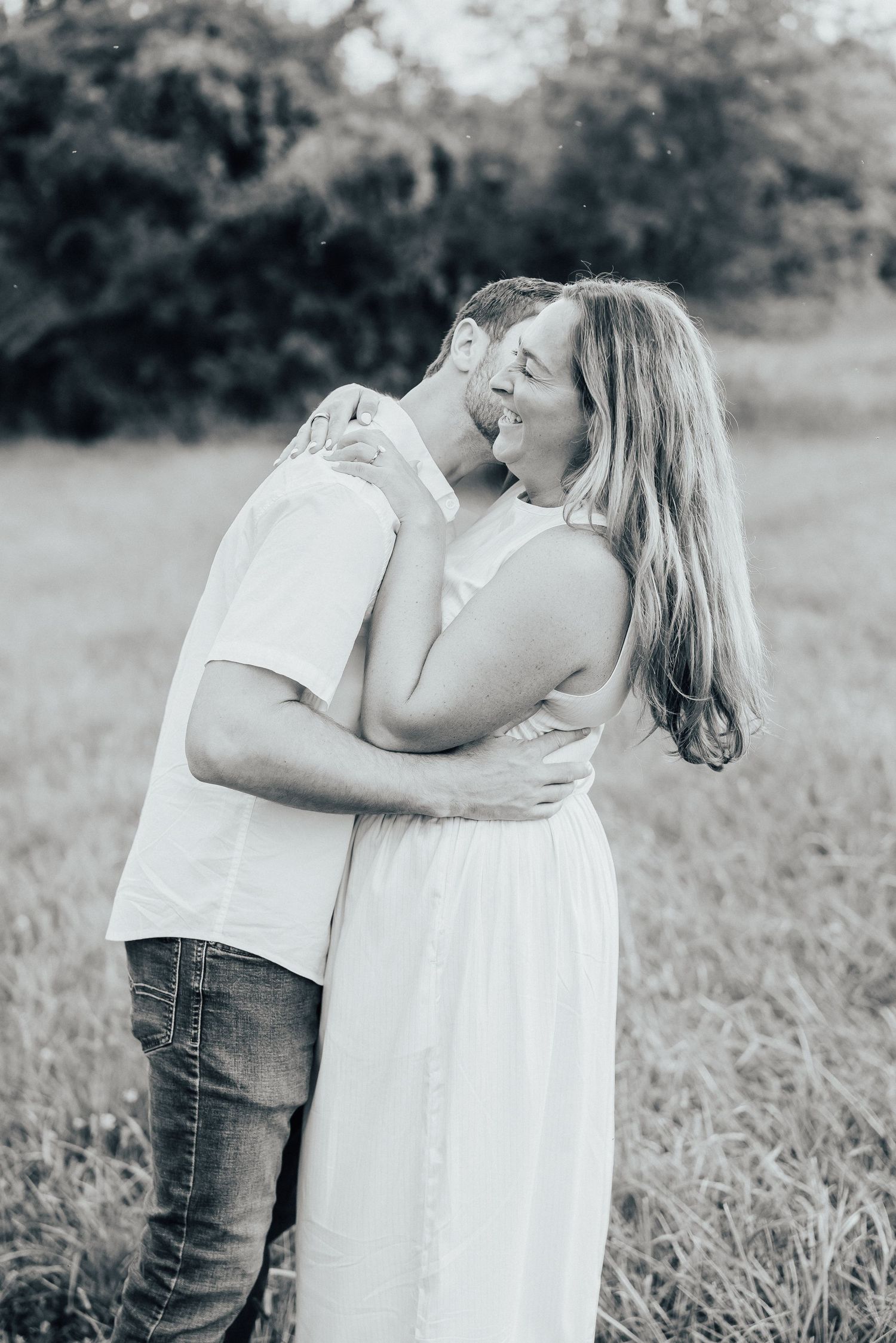 A romantic black and white photo series showing an intimate moment between a couple outdoors.