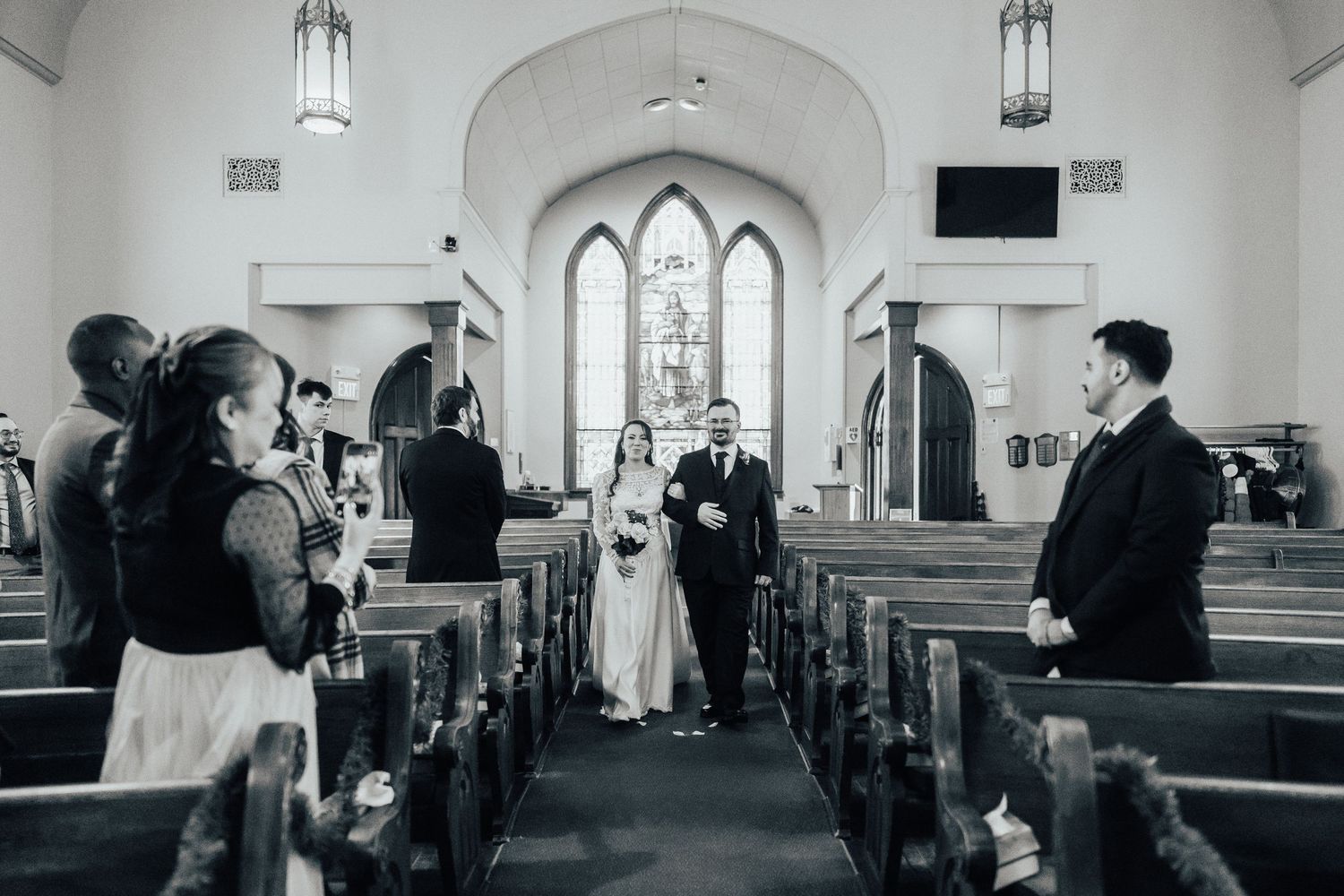 Black and white panoramic views of a church interior showing pews and arched architecture.