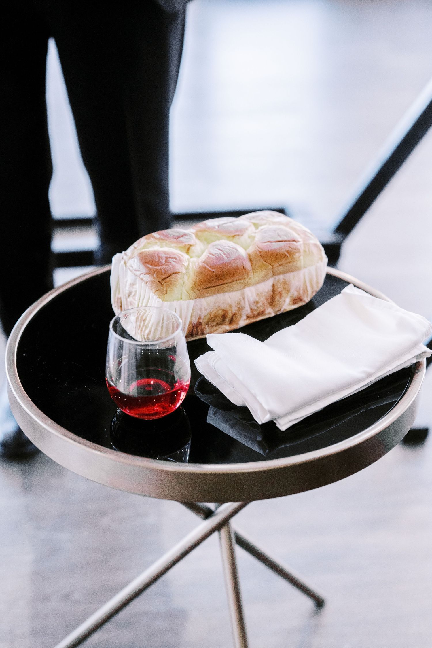 Wedding reception food and drinks being served on modern black trays.