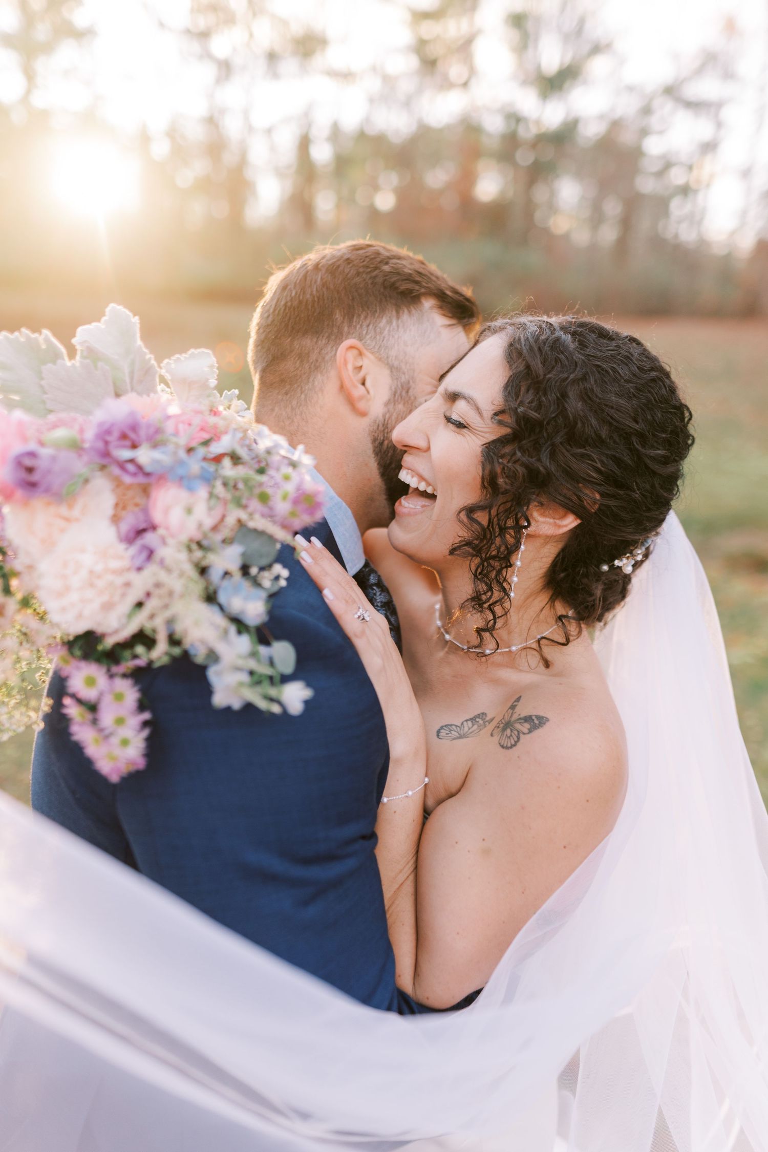 A romantic wedding couple embraces in a series of intimate sunset portraits with soft floral bouquet details.