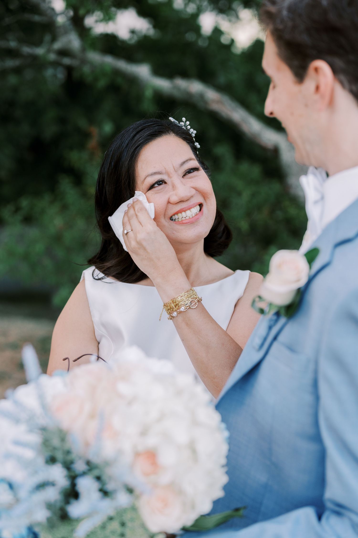 Wedding couple sharing an intimate moment with soft lighting and floral bouquet.