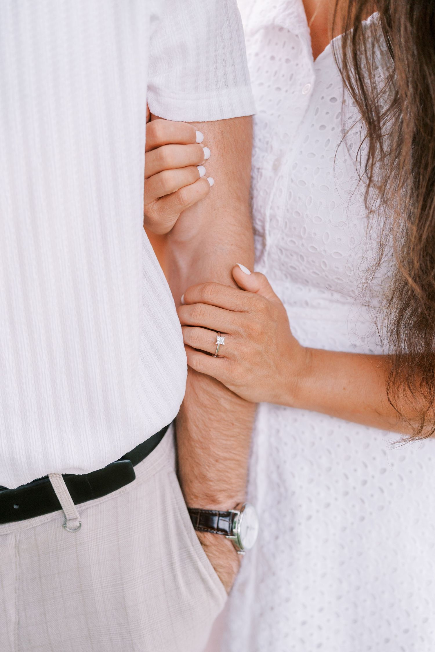 Close-up shots of hands embracing and holding each other, showing affection and connection.