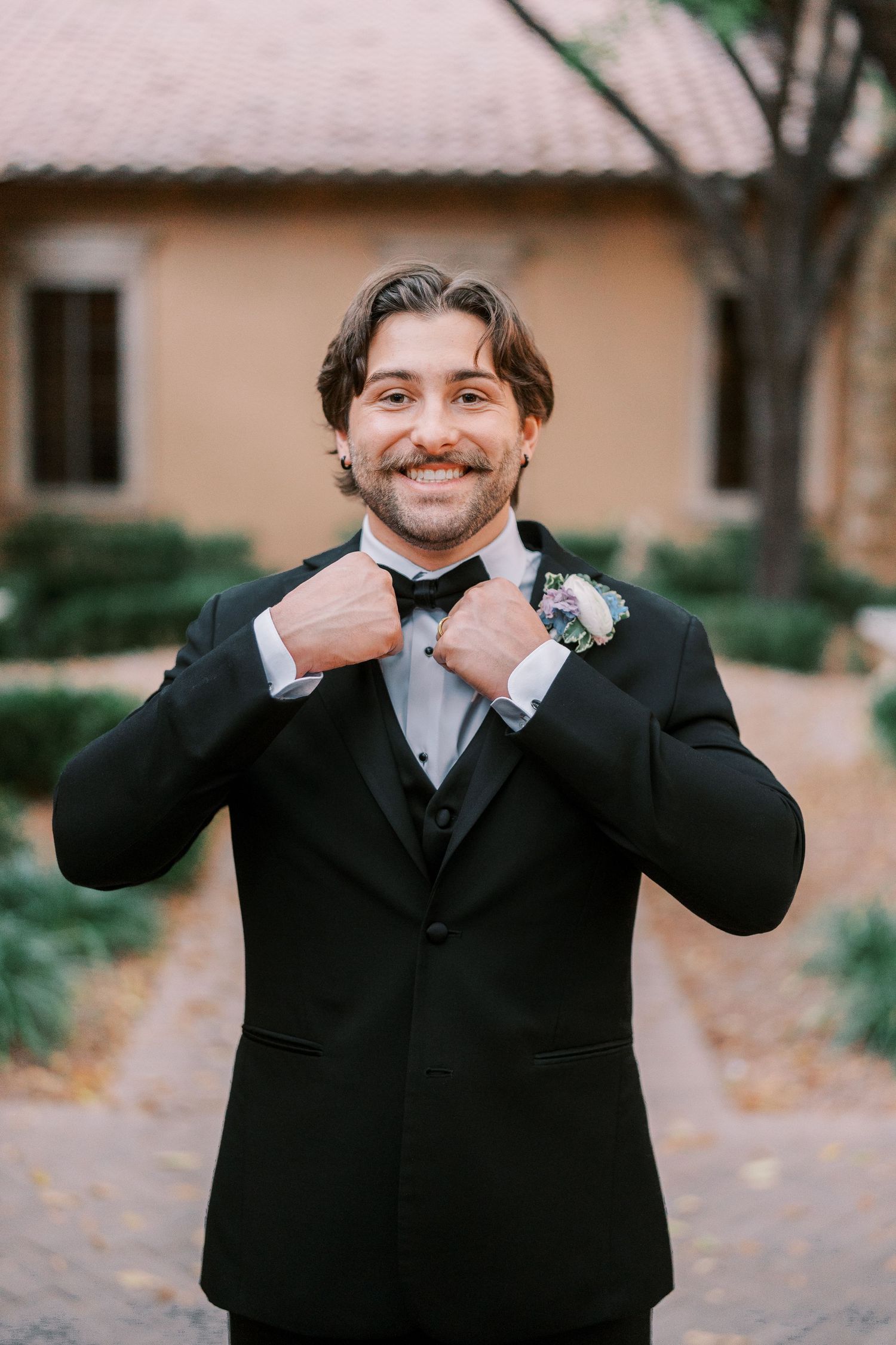 A series of four photos showing a groom in a black suit adjusting his bow tie and smiling at the camera.